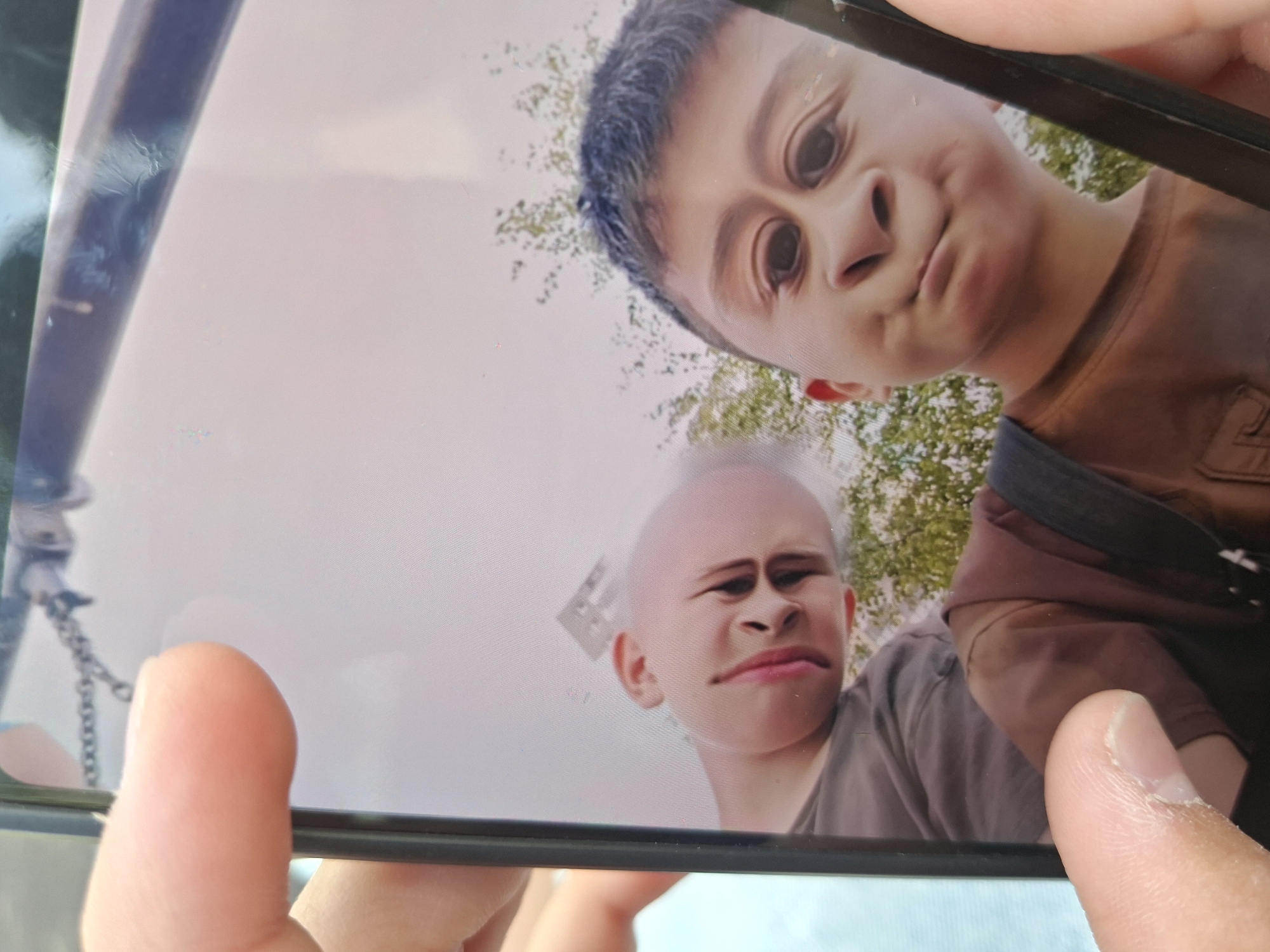 Boys play with phone filters at Saint Petersburg playground