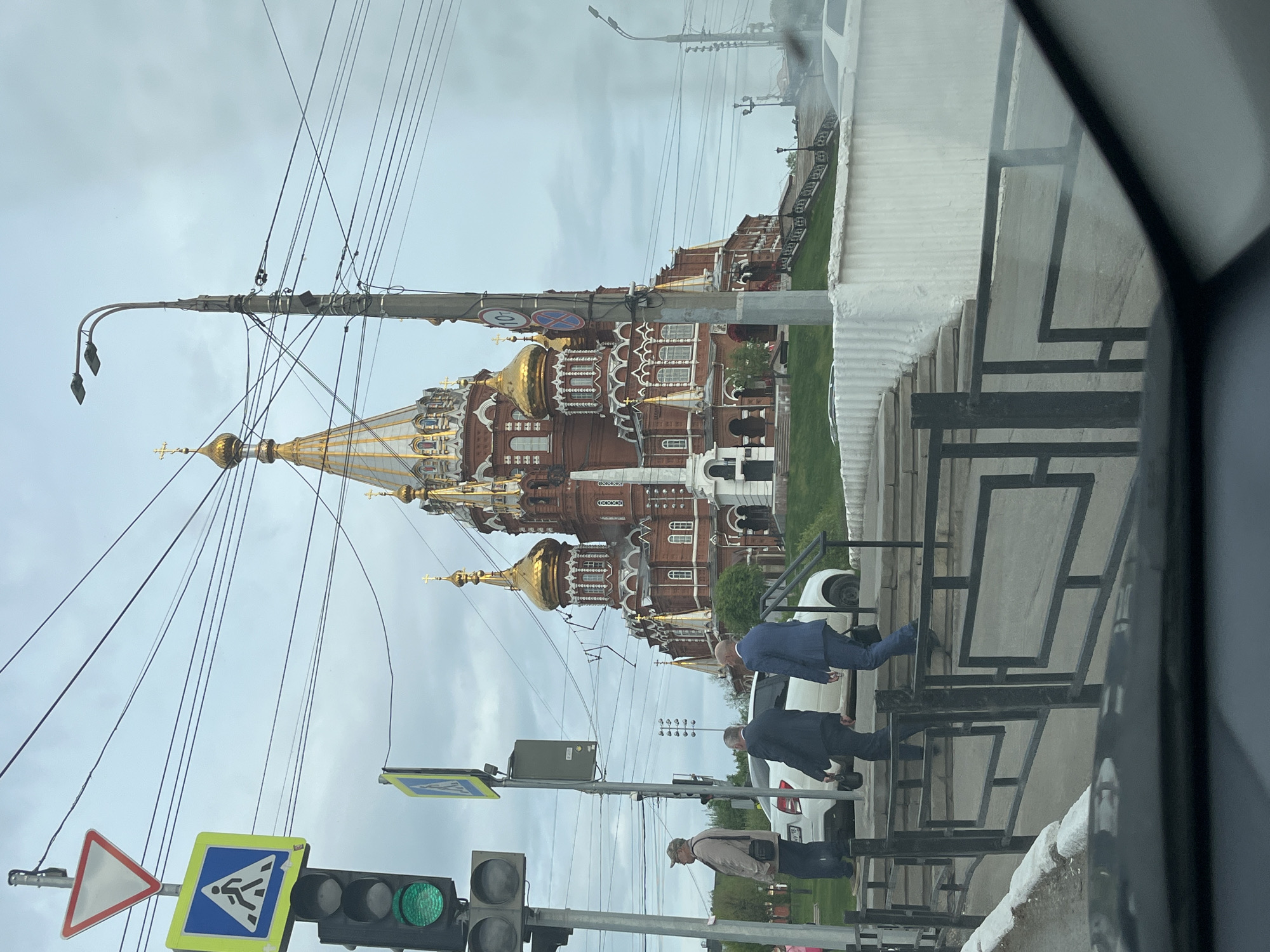 Woman drives past golden-domed cathedral in Izhevsk, Russia