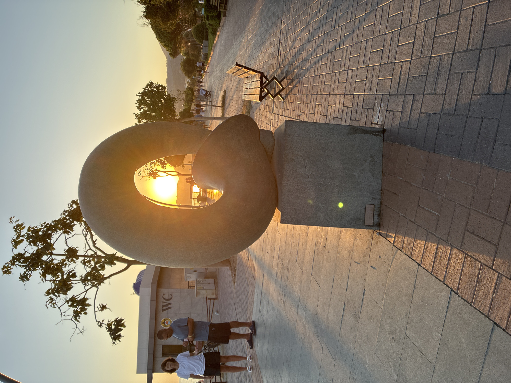 Sunset along Alanya's promenade, cats, sculptures, and beach crowds