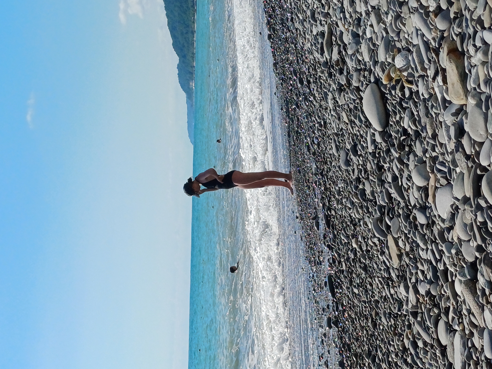 Summer beach day at Sochi's Black Sea pebble shore