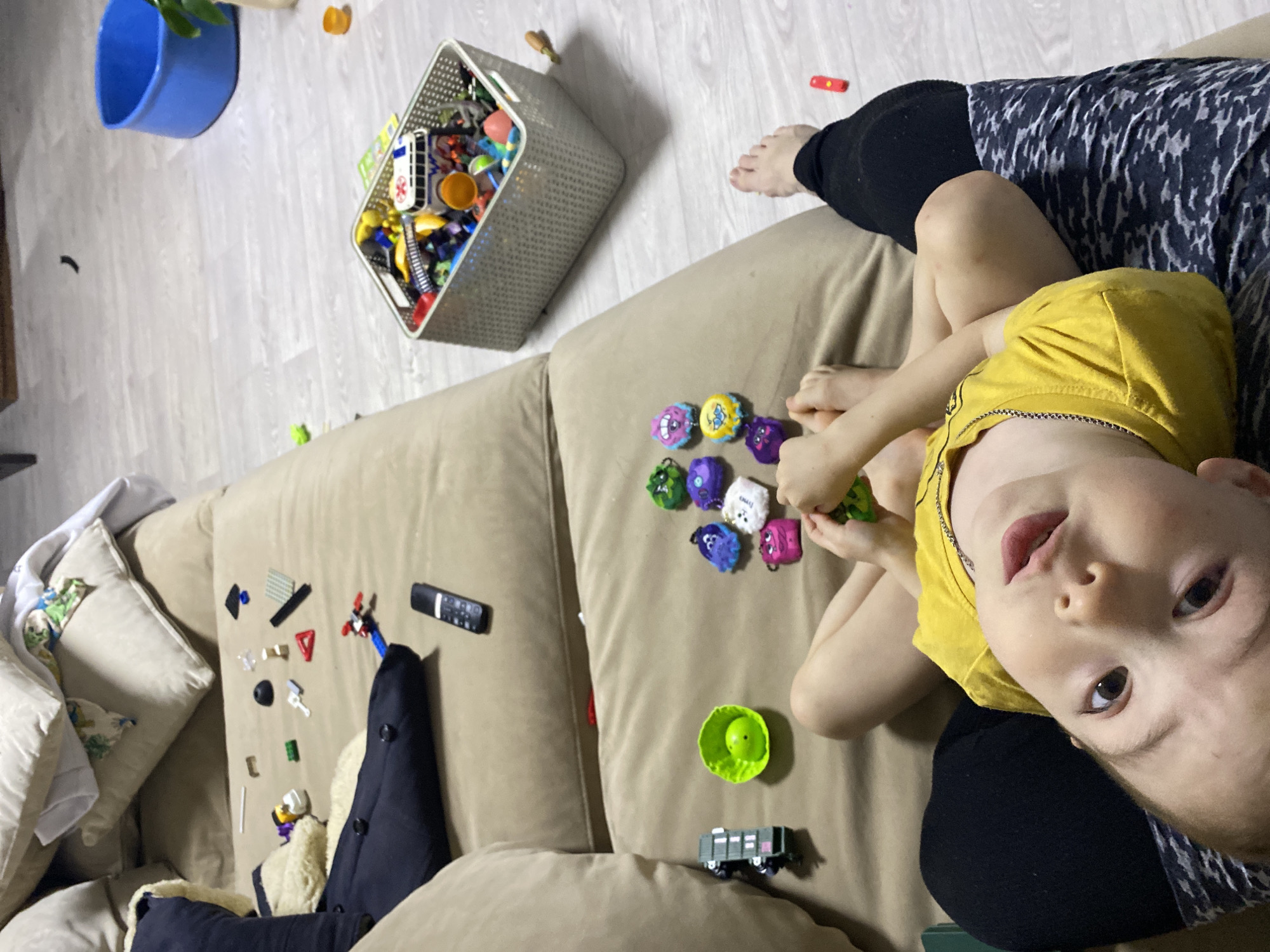 Child in yellow shirt rests on sofa in Noviy