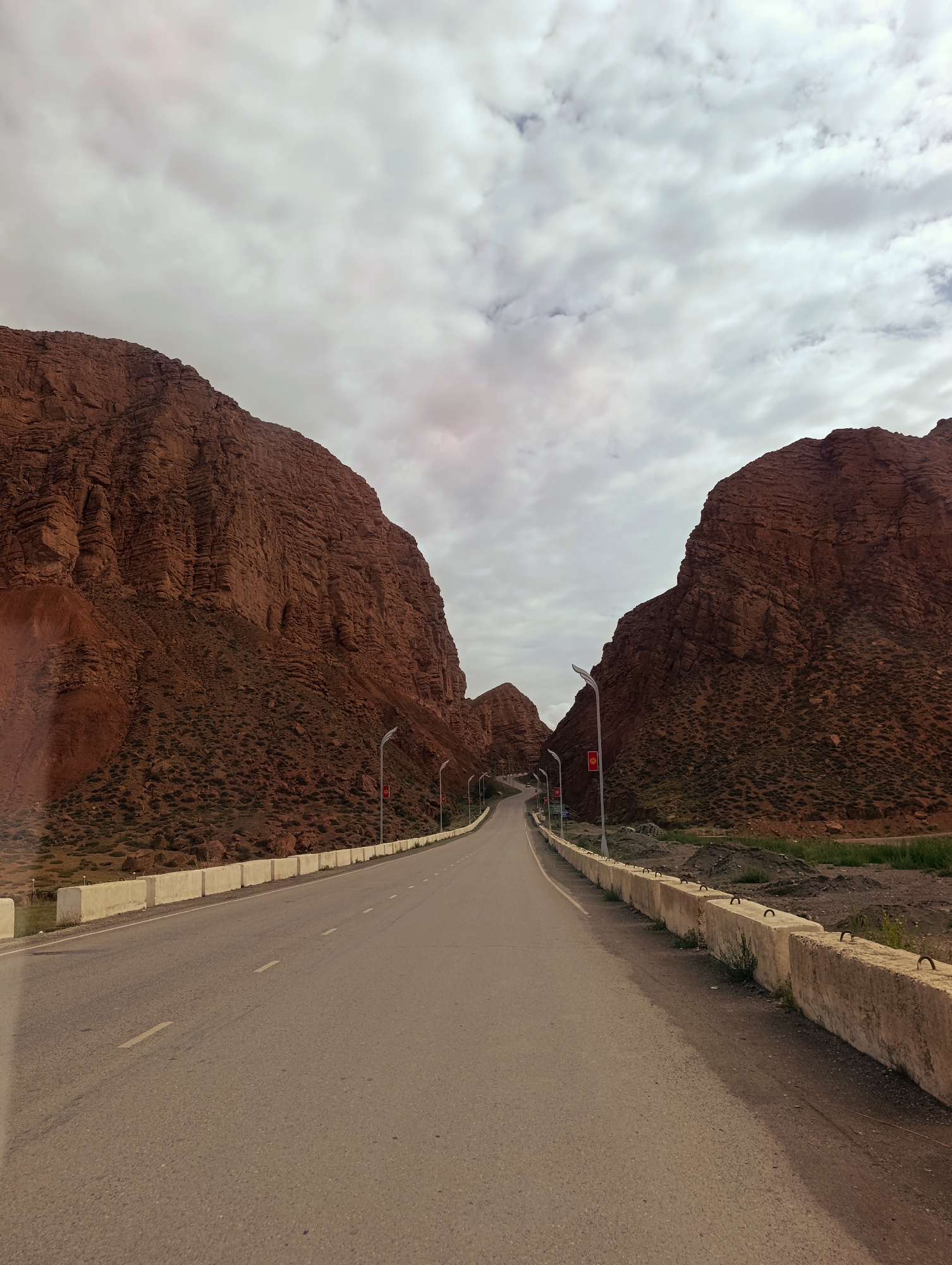Highway threading through a red-rock gorge near Naryn, Kyrgyzstan