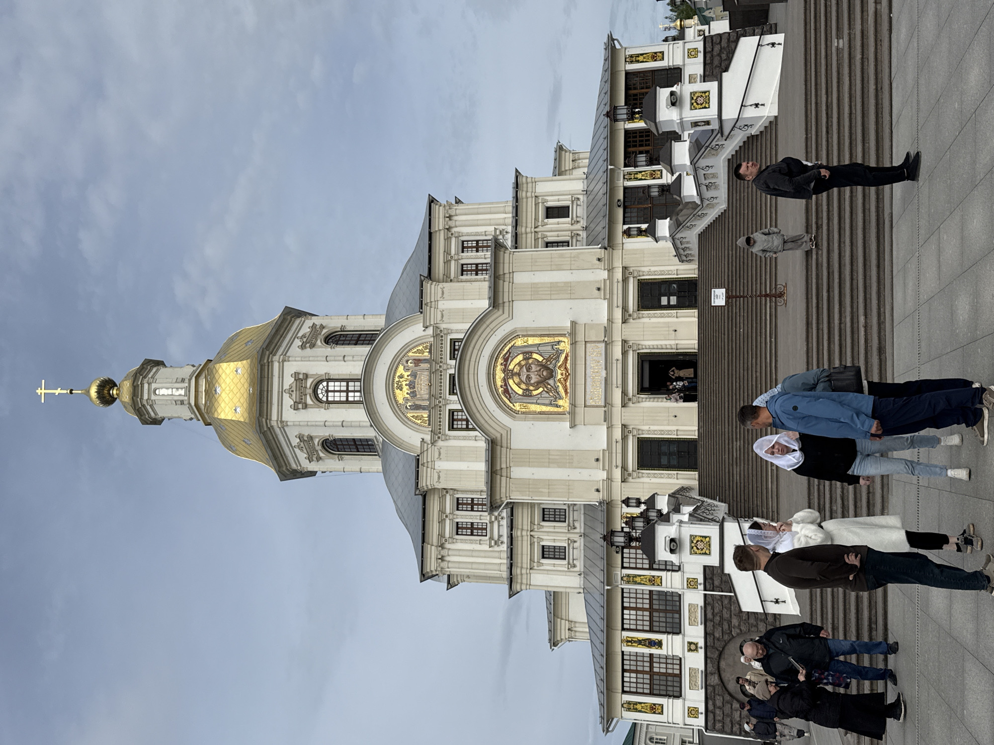Visitors gather at historic Diveyevo Monastery under cloudy skies