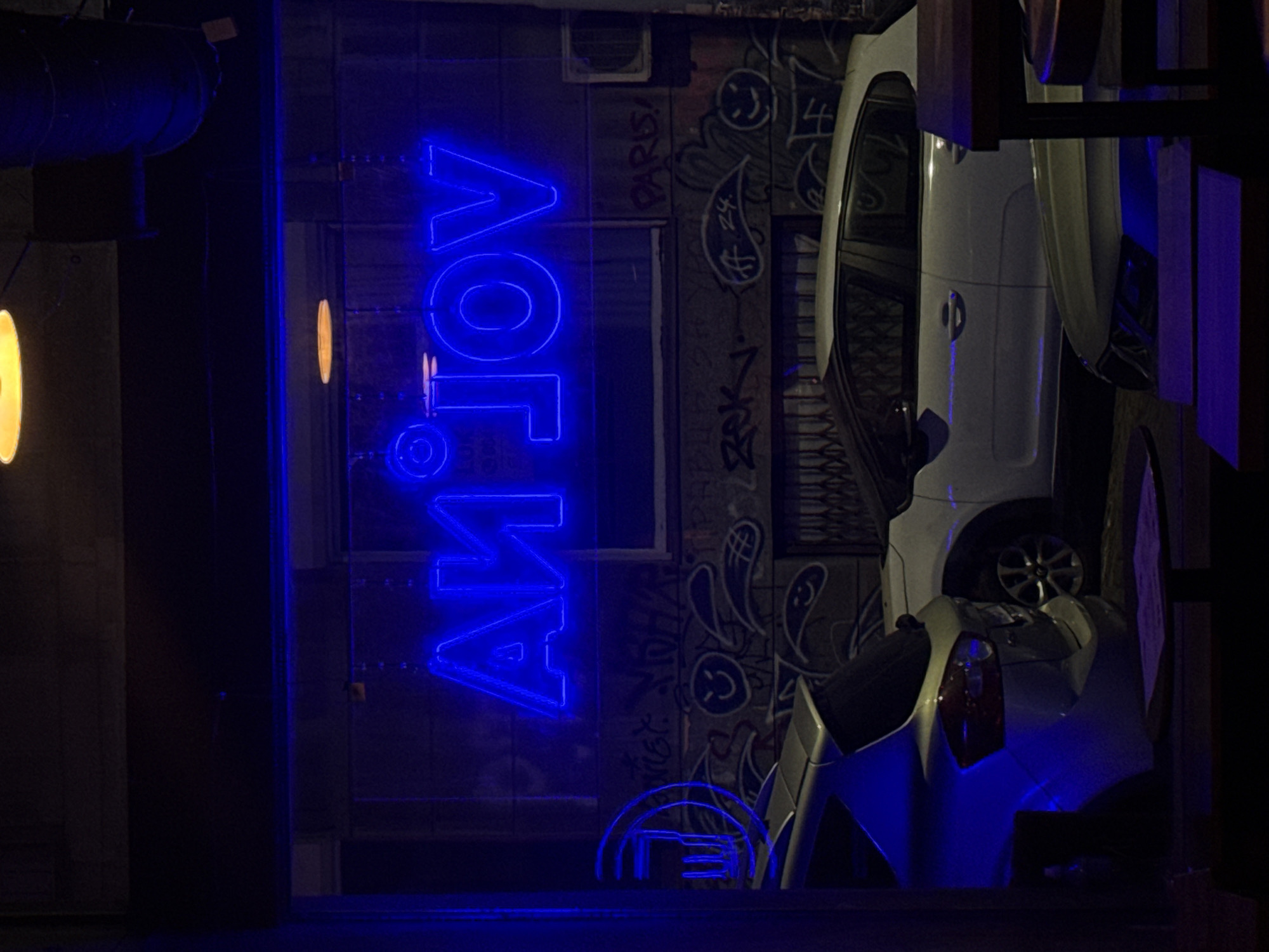 Drinks and snacks at a neon-lit bar late evening