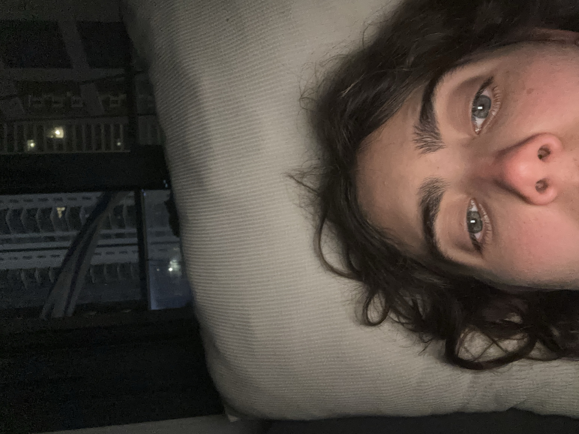Person photographed resting on pillow indoors in Jordan