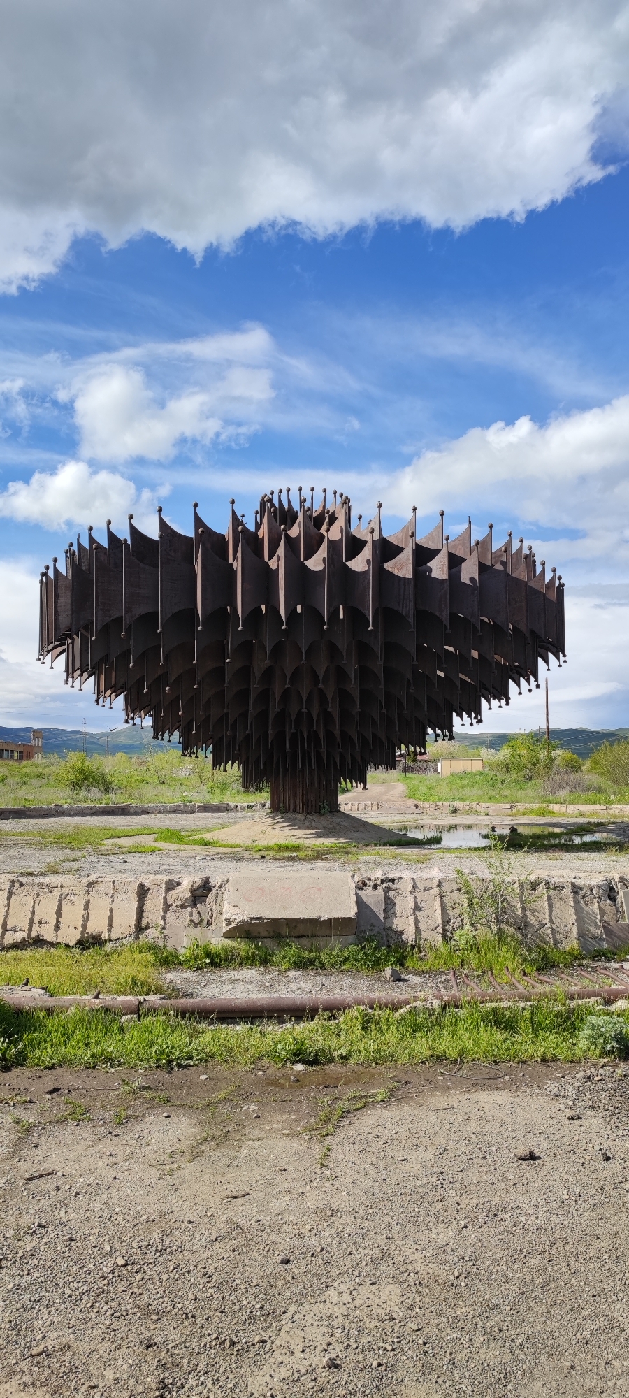 Urban scenes documented in Gyumri: decaying sculpture, stray dog