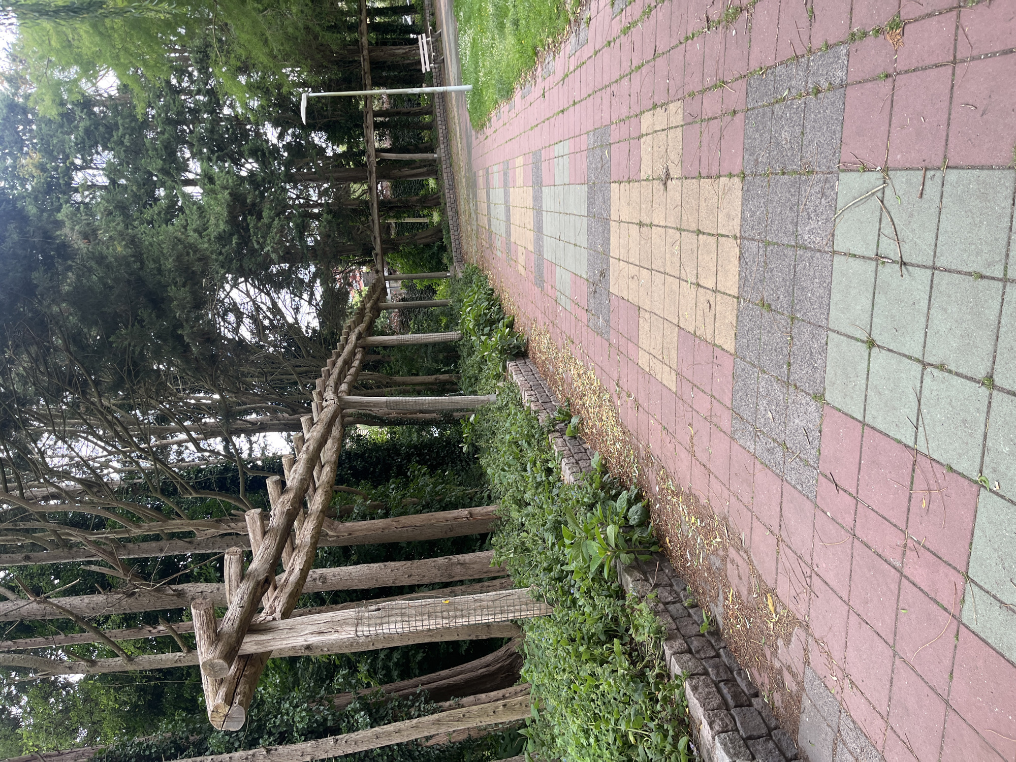 Park walkway with fountains and pergola structures