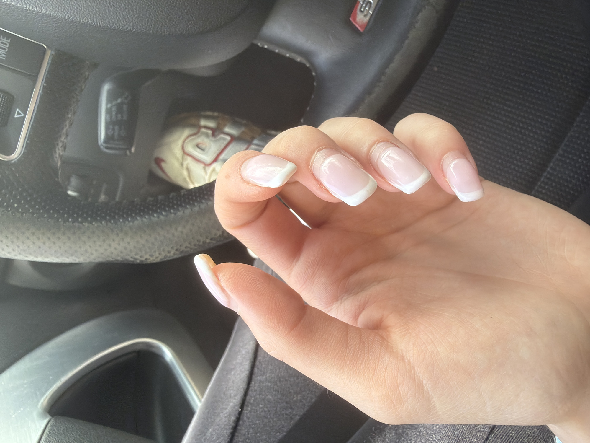 French manicured hand photographed over steering wheel in Smolyan