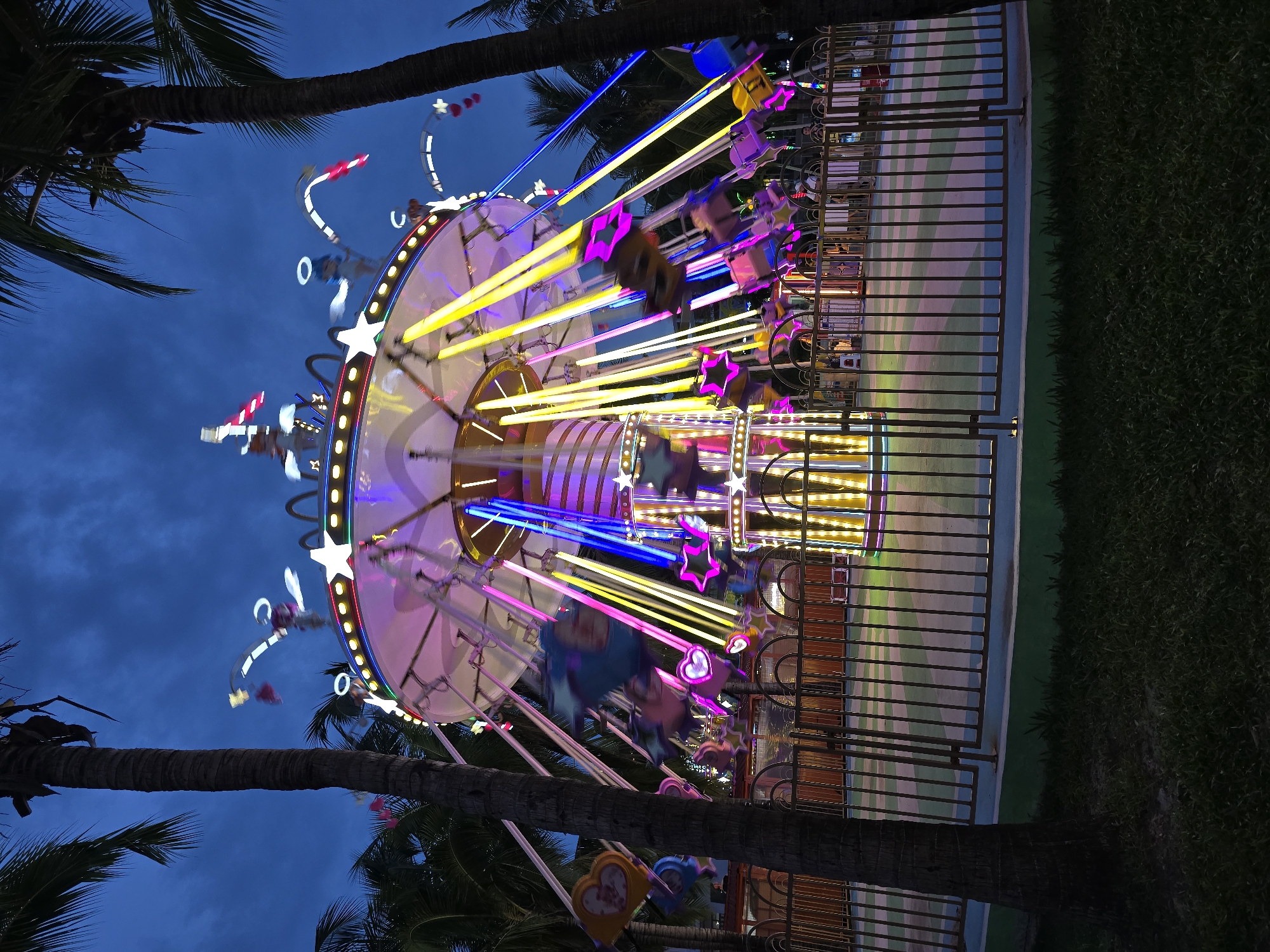 Colorful carousel ride glowing at night in Hainan