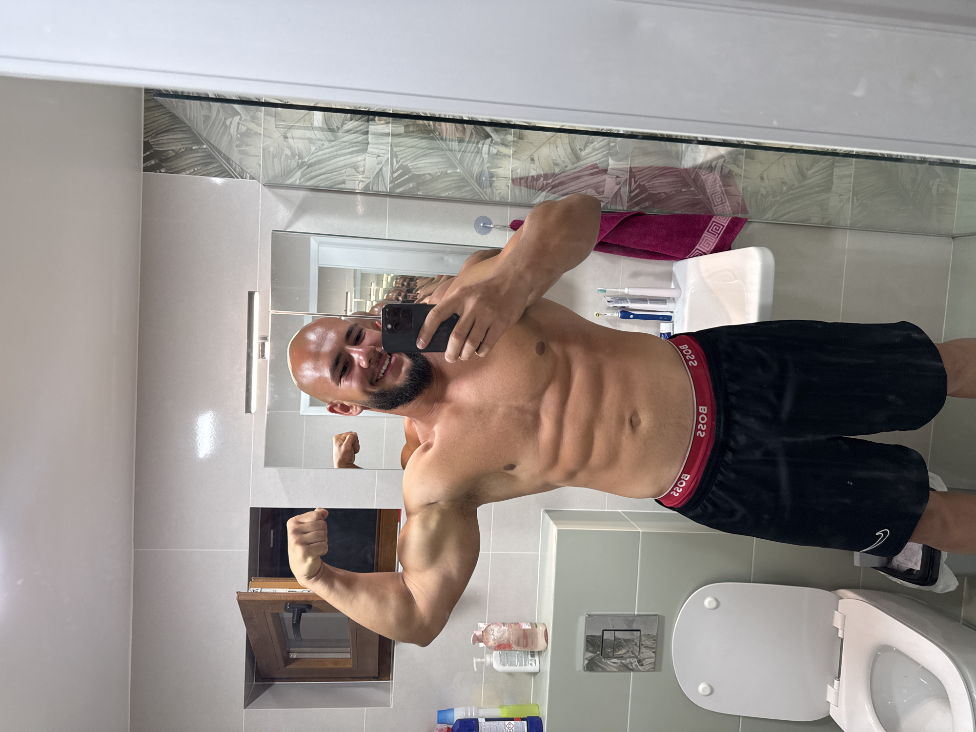 Mirror selfies in a Sofia bathroom, flexing for the camera