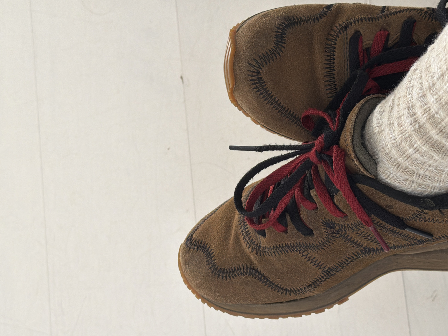 Brown suede shoes photographed from above in Como, Italy