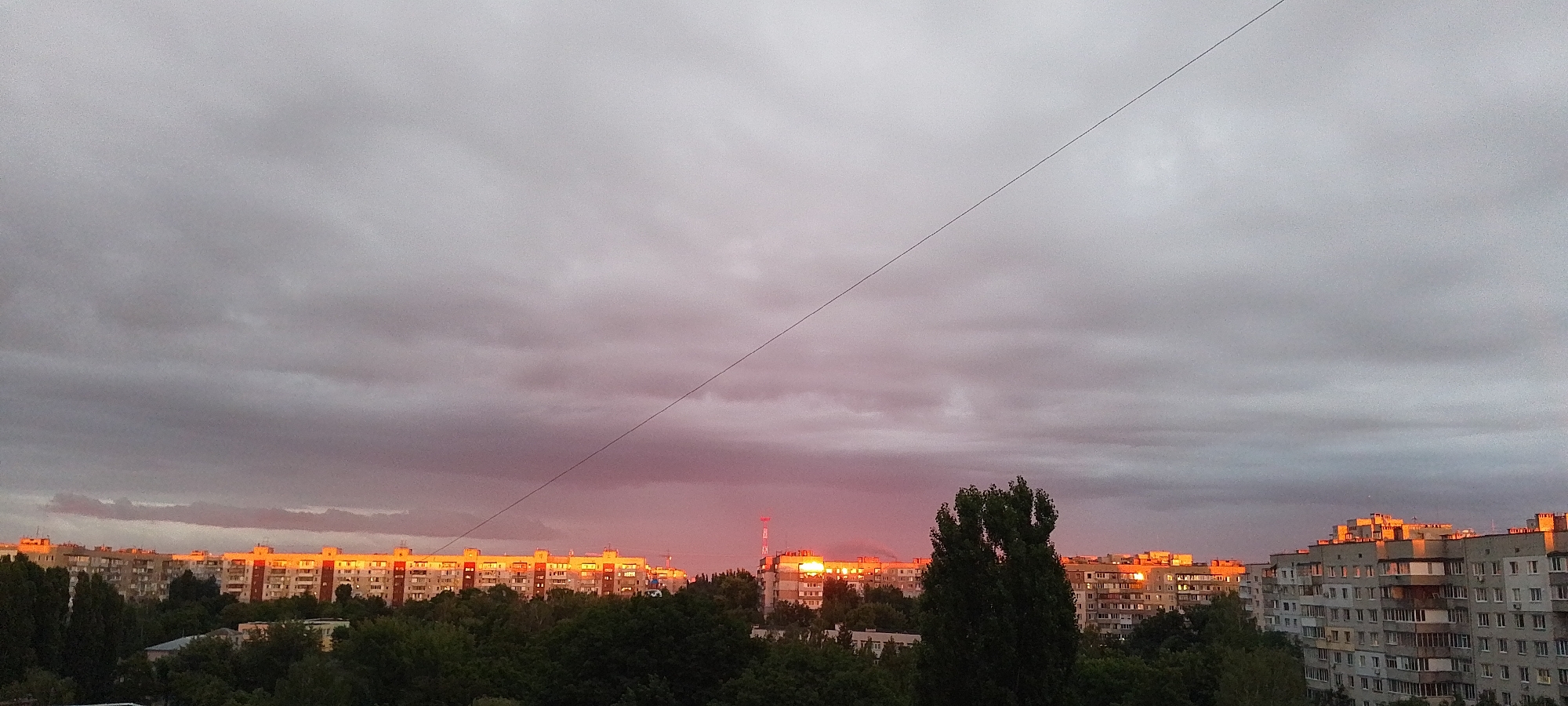 Pinkish-orange sunset clouds hang over Cherkasy, Ukraine