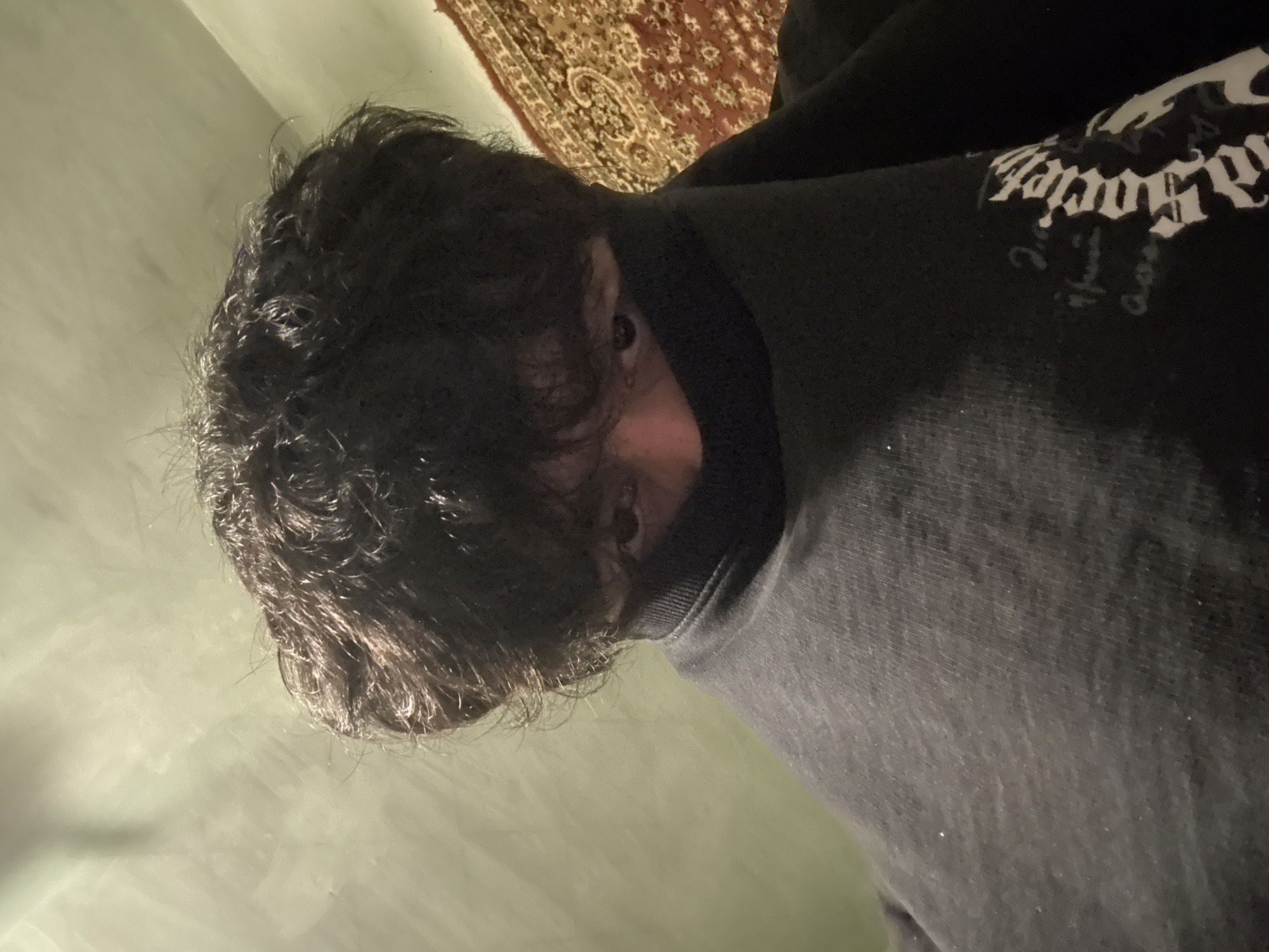 Person in black hooded sweatshirt photographed indoors in Yerevan