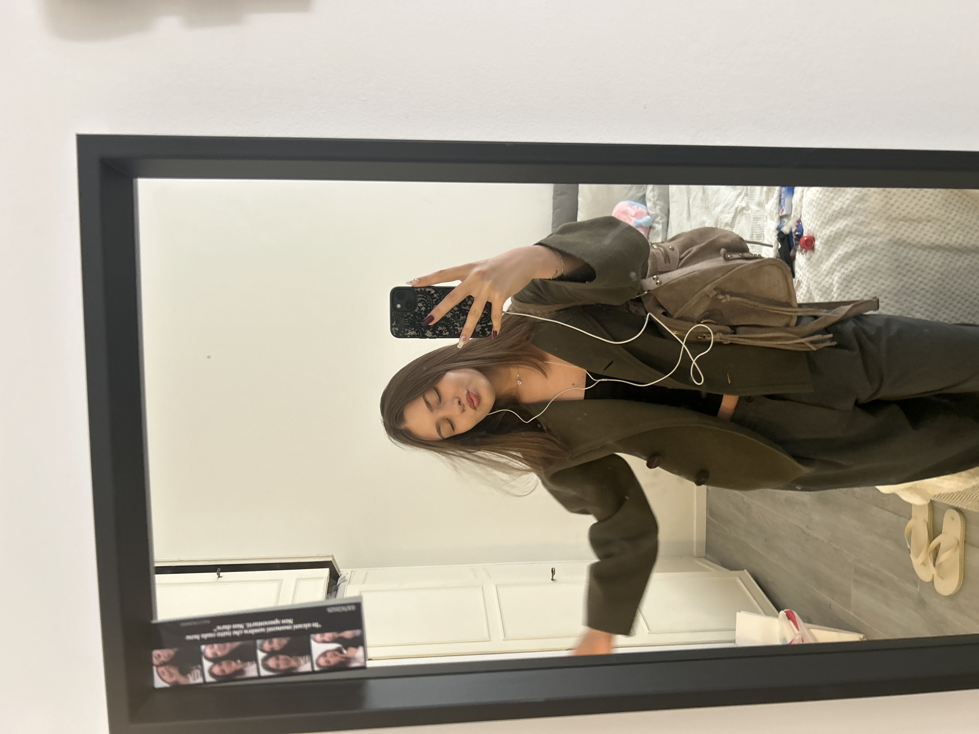 Woman takes mirror selfies in Milan apartment Thursday morning