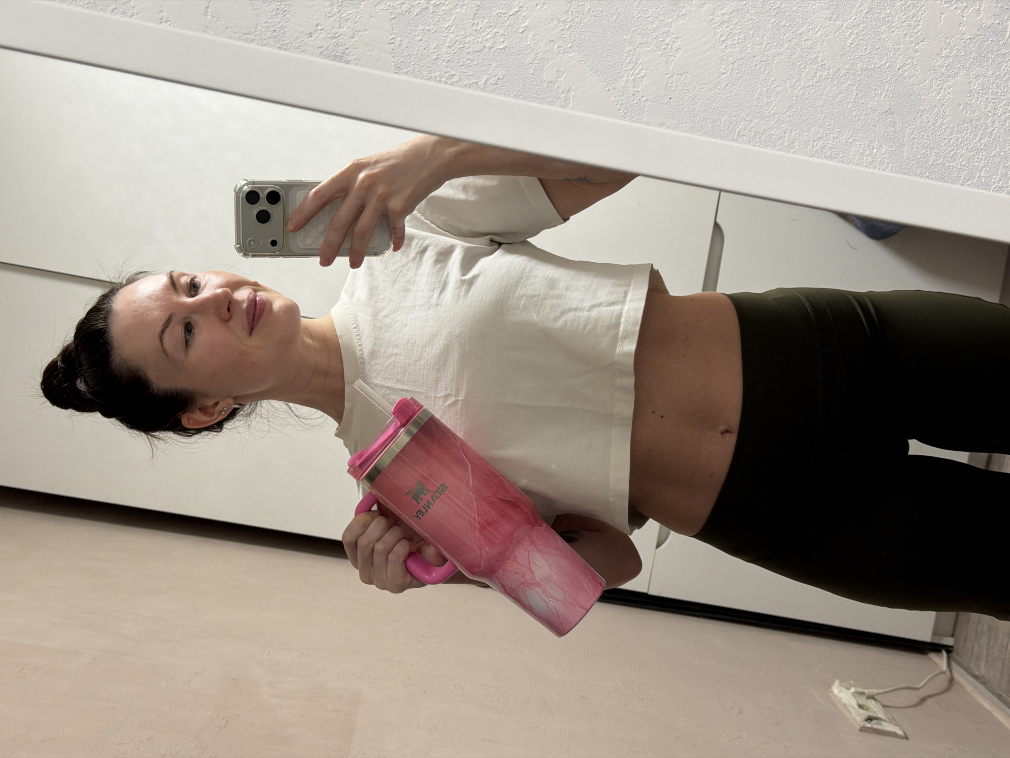 Woman takes mirror selfie in athletic wear in Perm