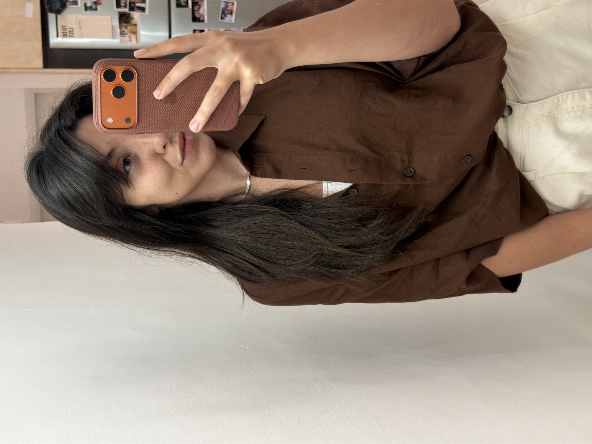 Woman takes indoor selfie with iPhone in Givatayim