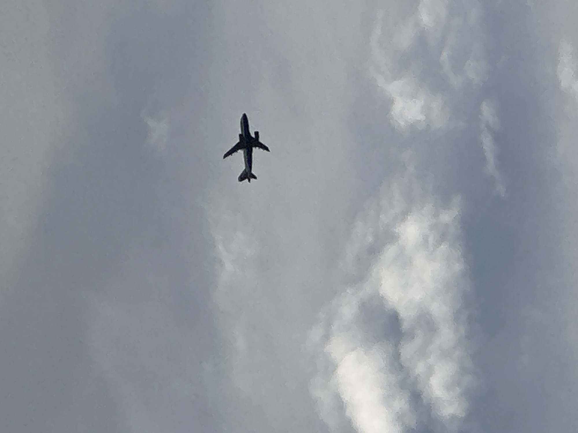 Commercial jet ascending through cloudy skies over London