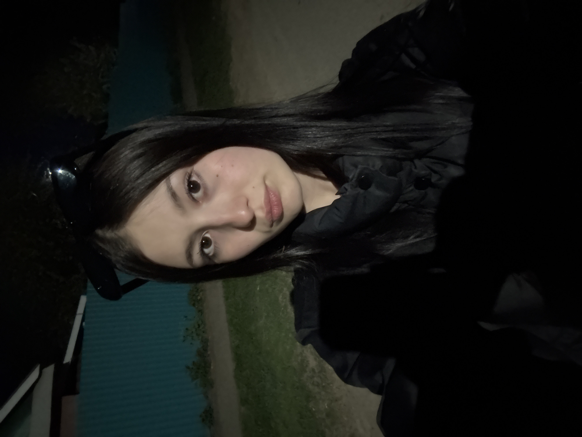Woman takes evening selfies in residential Фоки, Russia