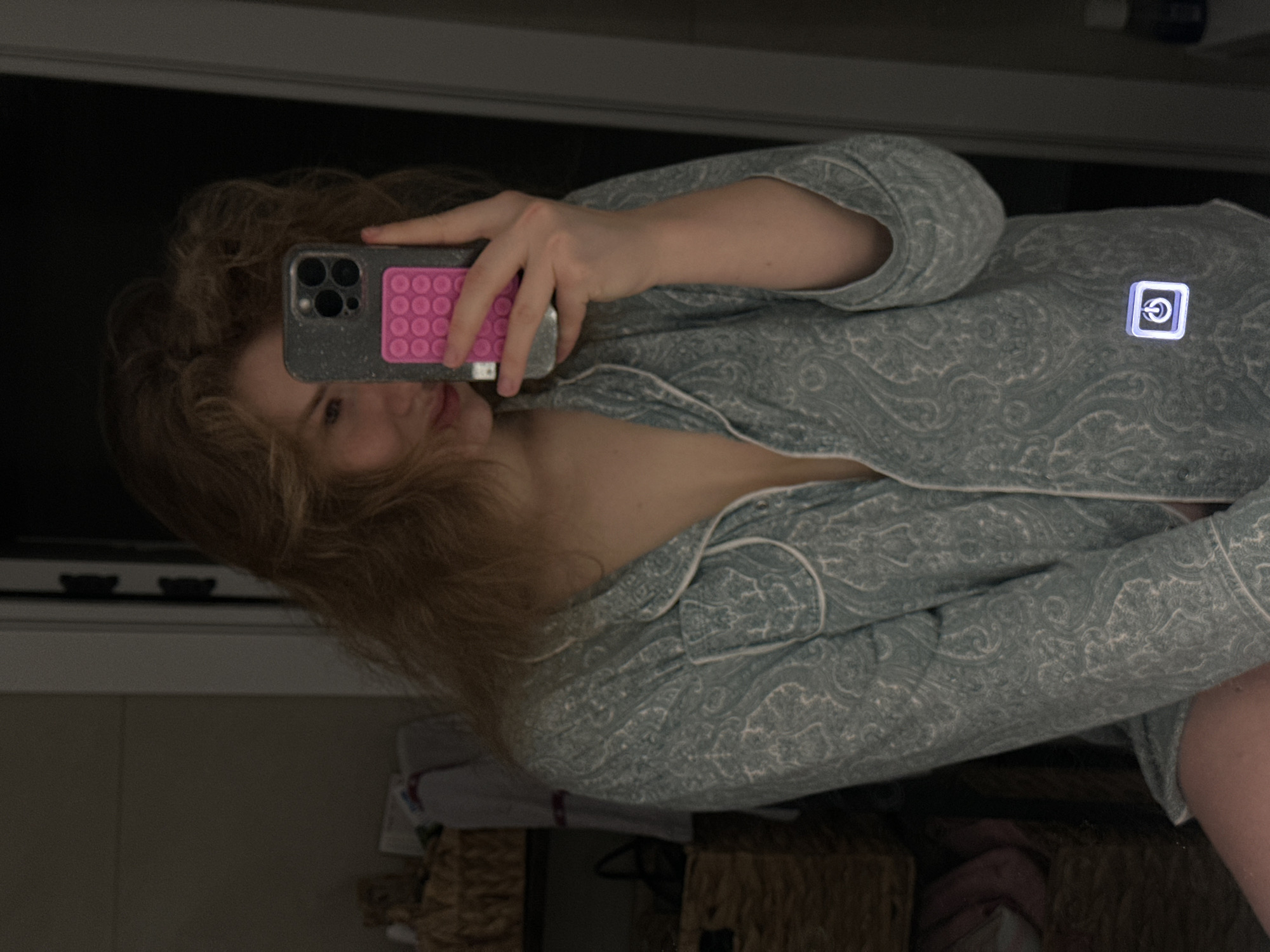 Woman takes mirror selfie in patterned pajamas in Kazan