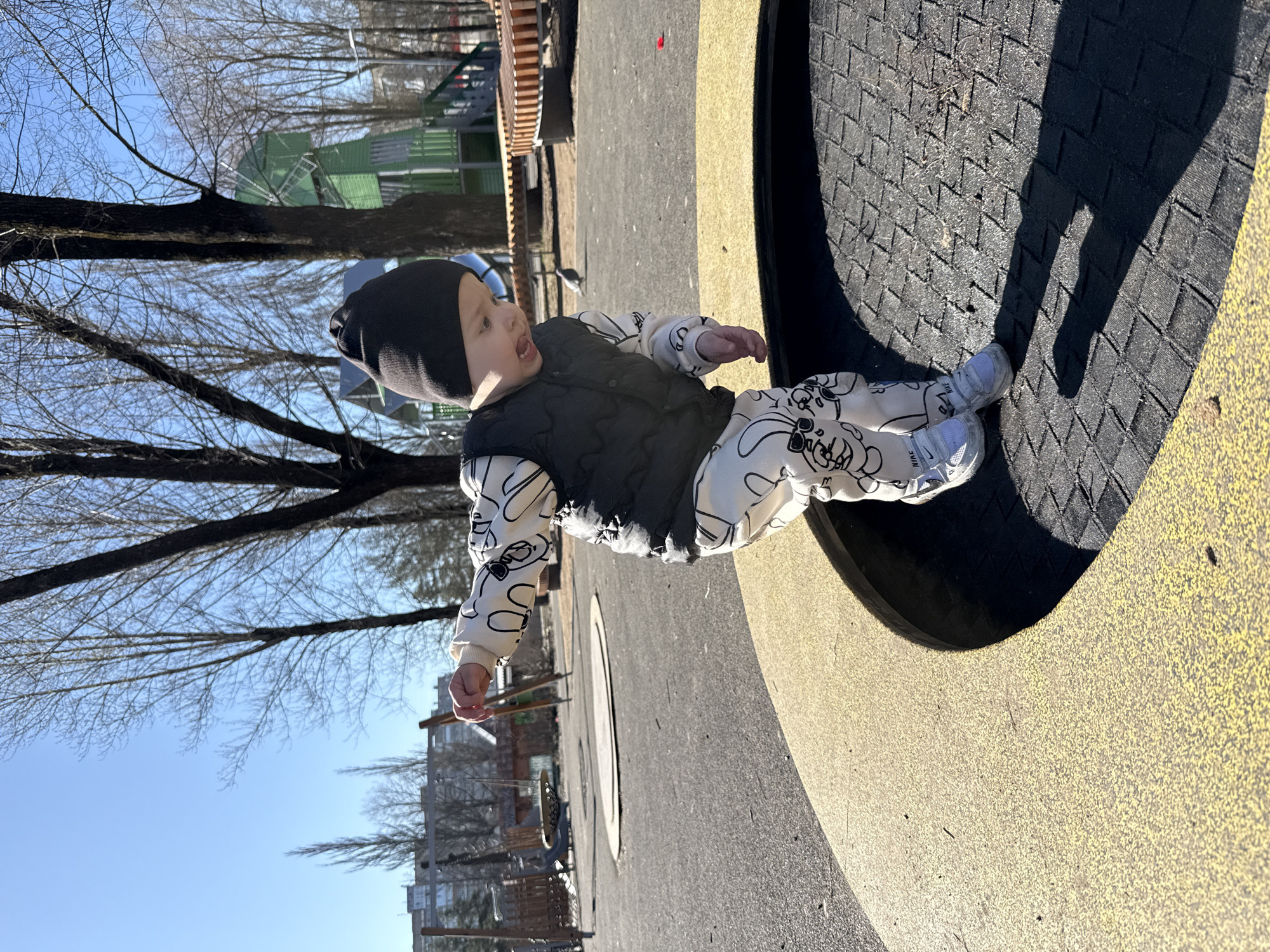 Child in winter clothing spotted on playground equipment