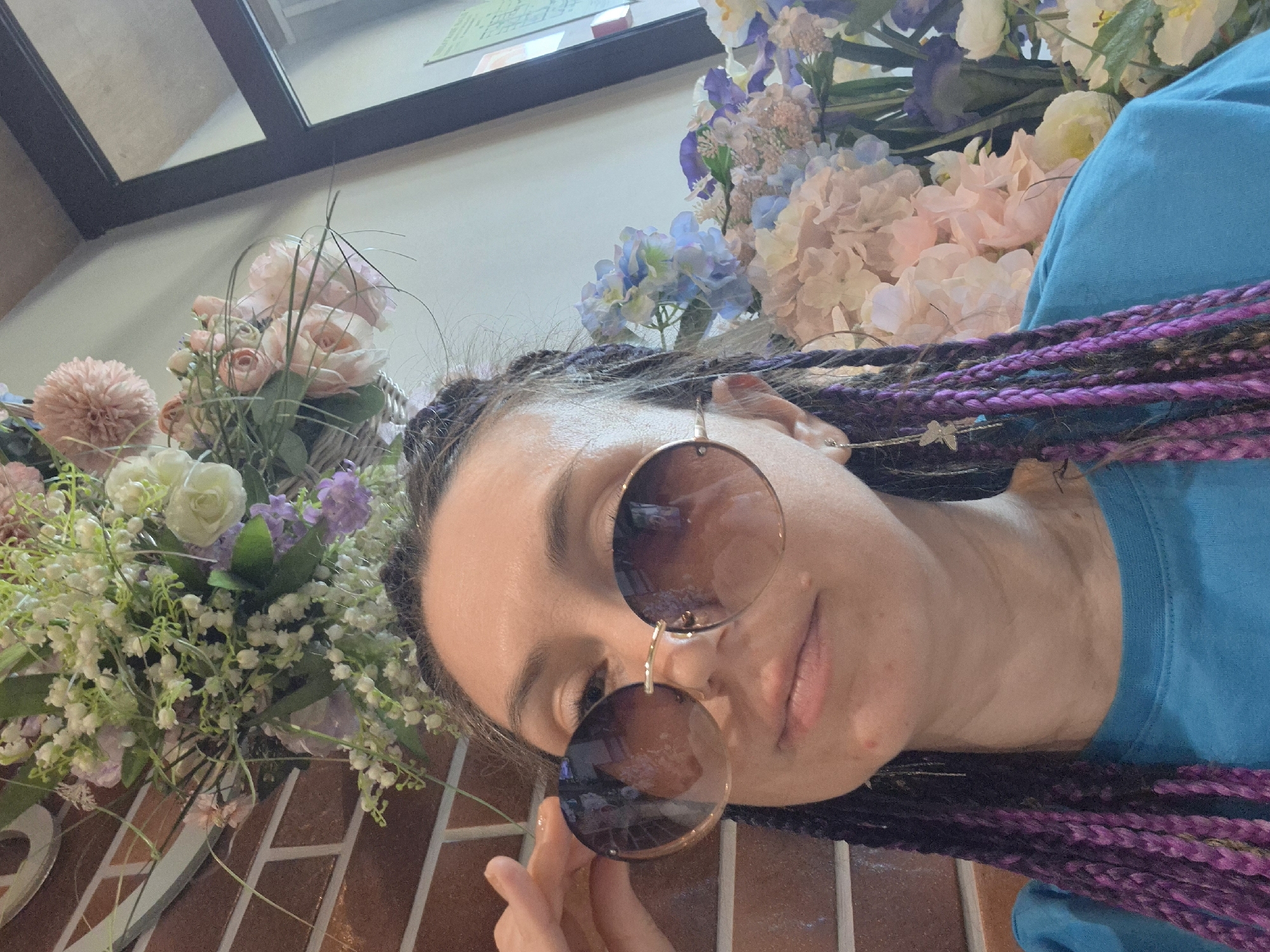 Woman poses for photos at flower-filled cafe in Votkinsk