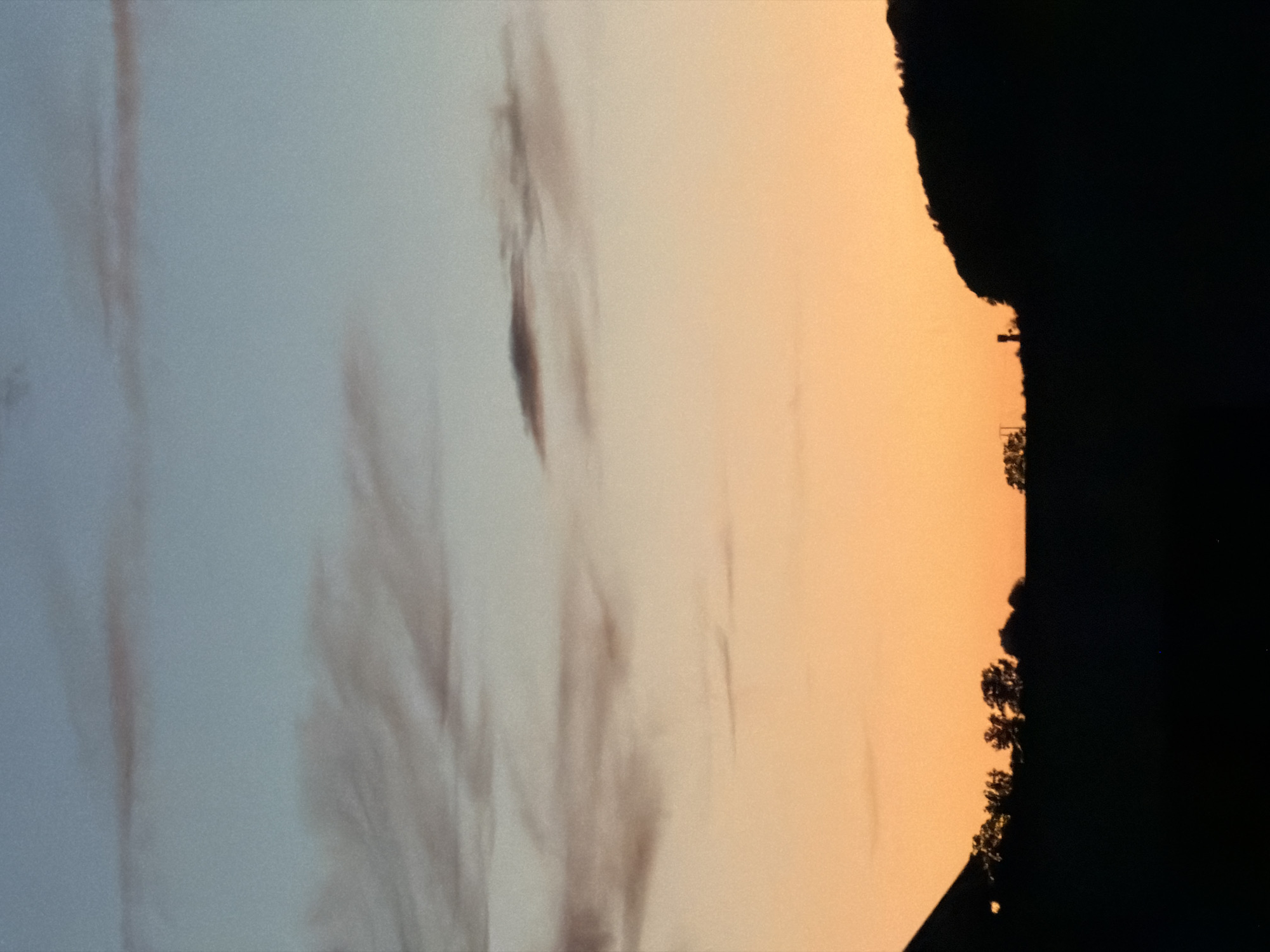 Sunset over Junglinster countryside creates dramatic twilight display