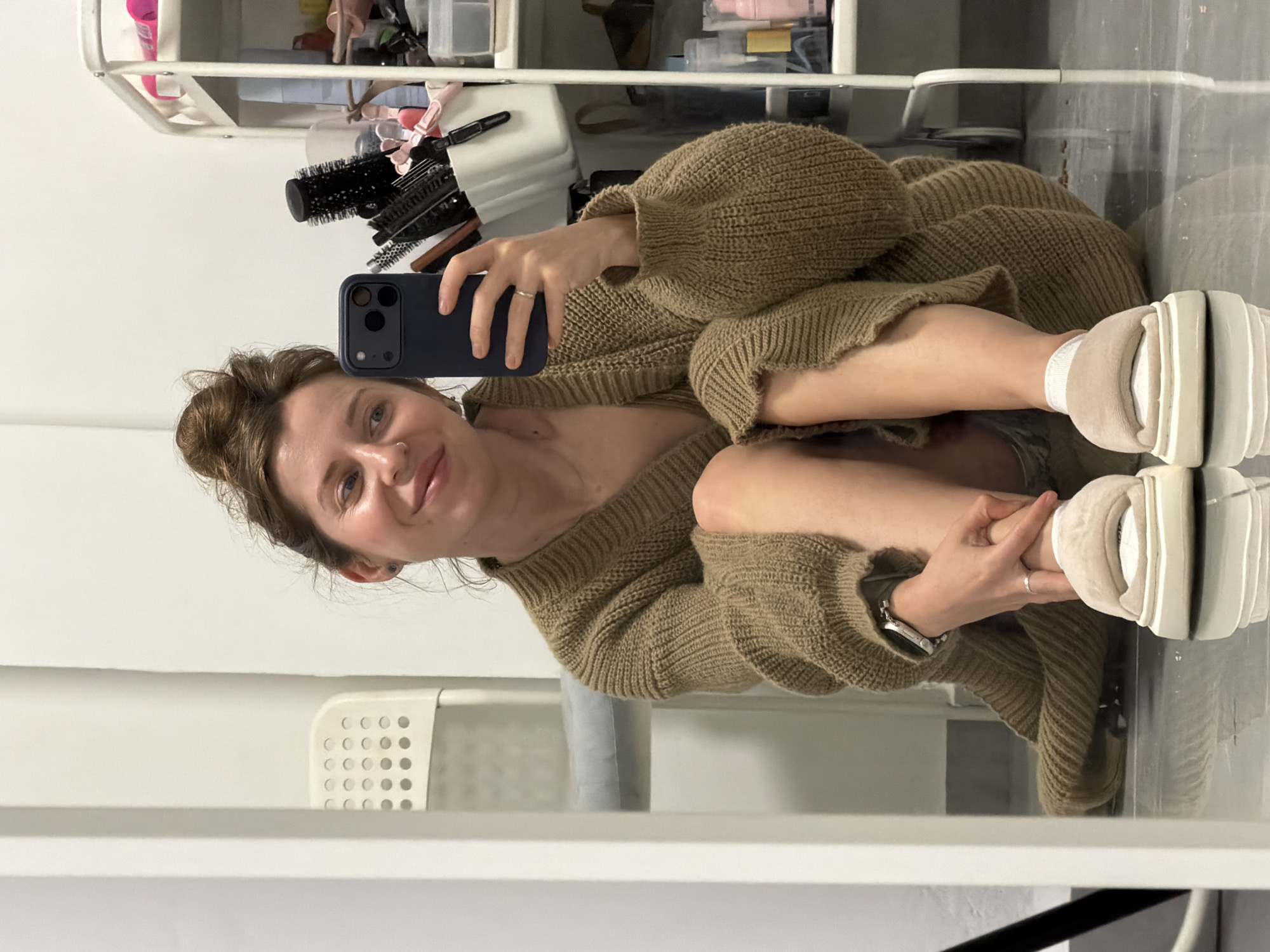 Woman takes mirror selfie in Bat Yam apartment