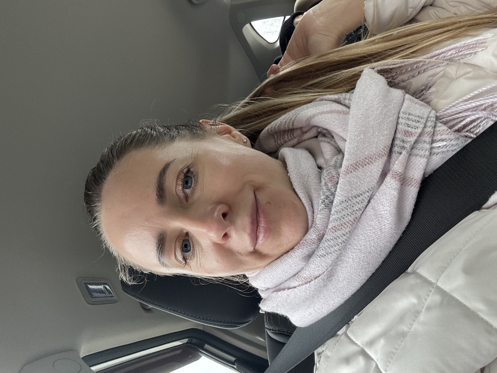 Woman in car, boom lift observed in rainy Chaikovsky