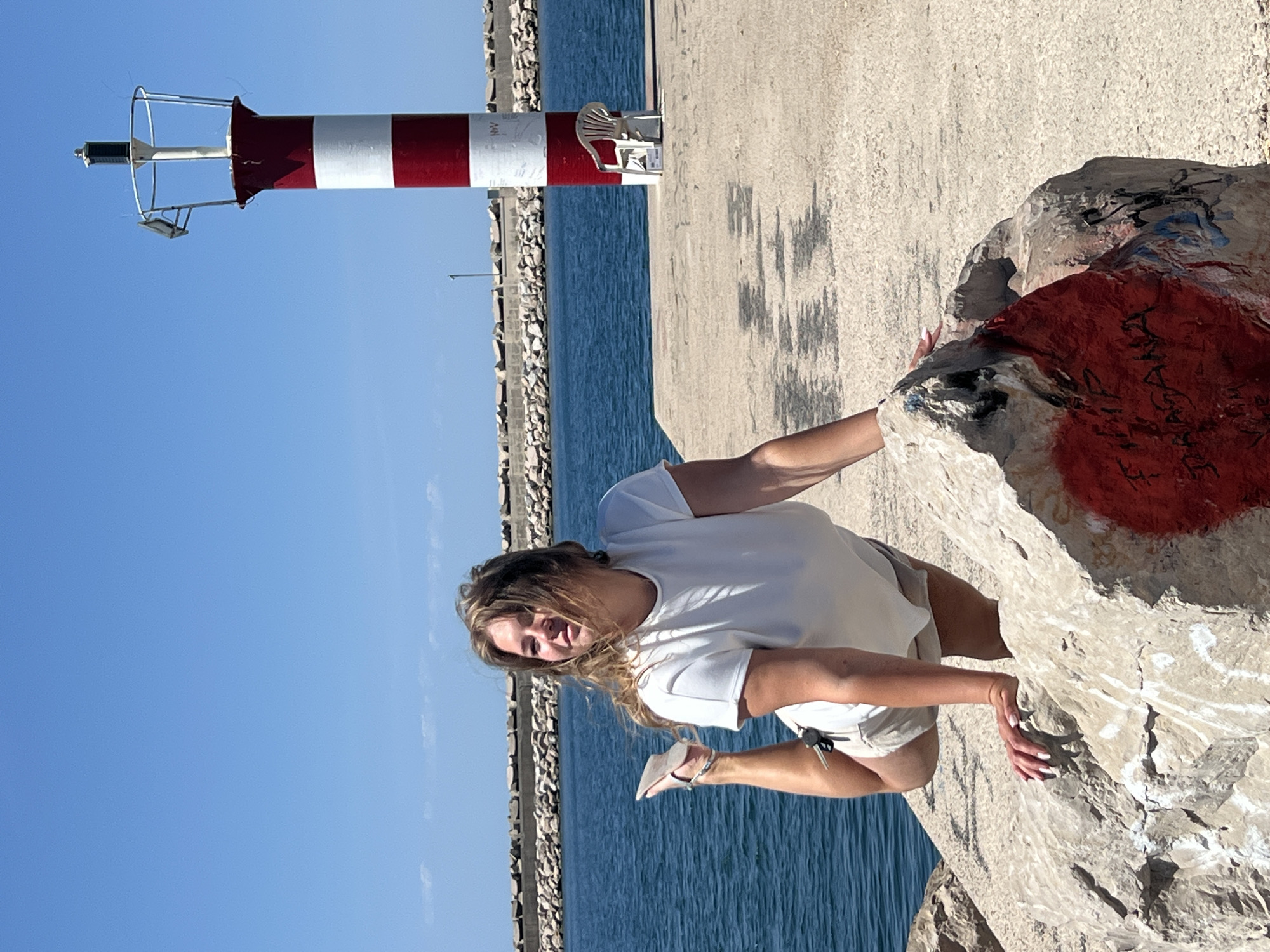 Woman photographed posing at sunny coastal pier in Bar, Montenegro