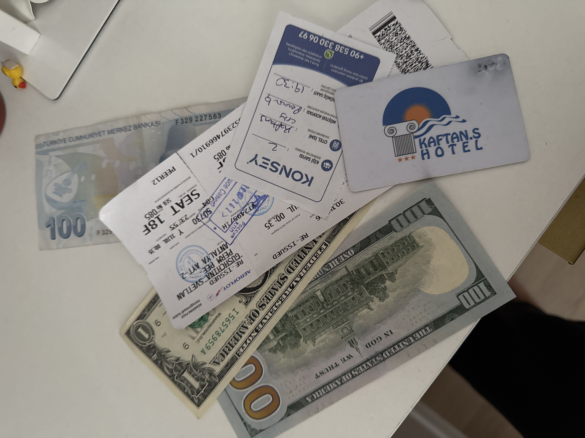 Post-trip room spread in Perm, travel cash and boarding pass visible