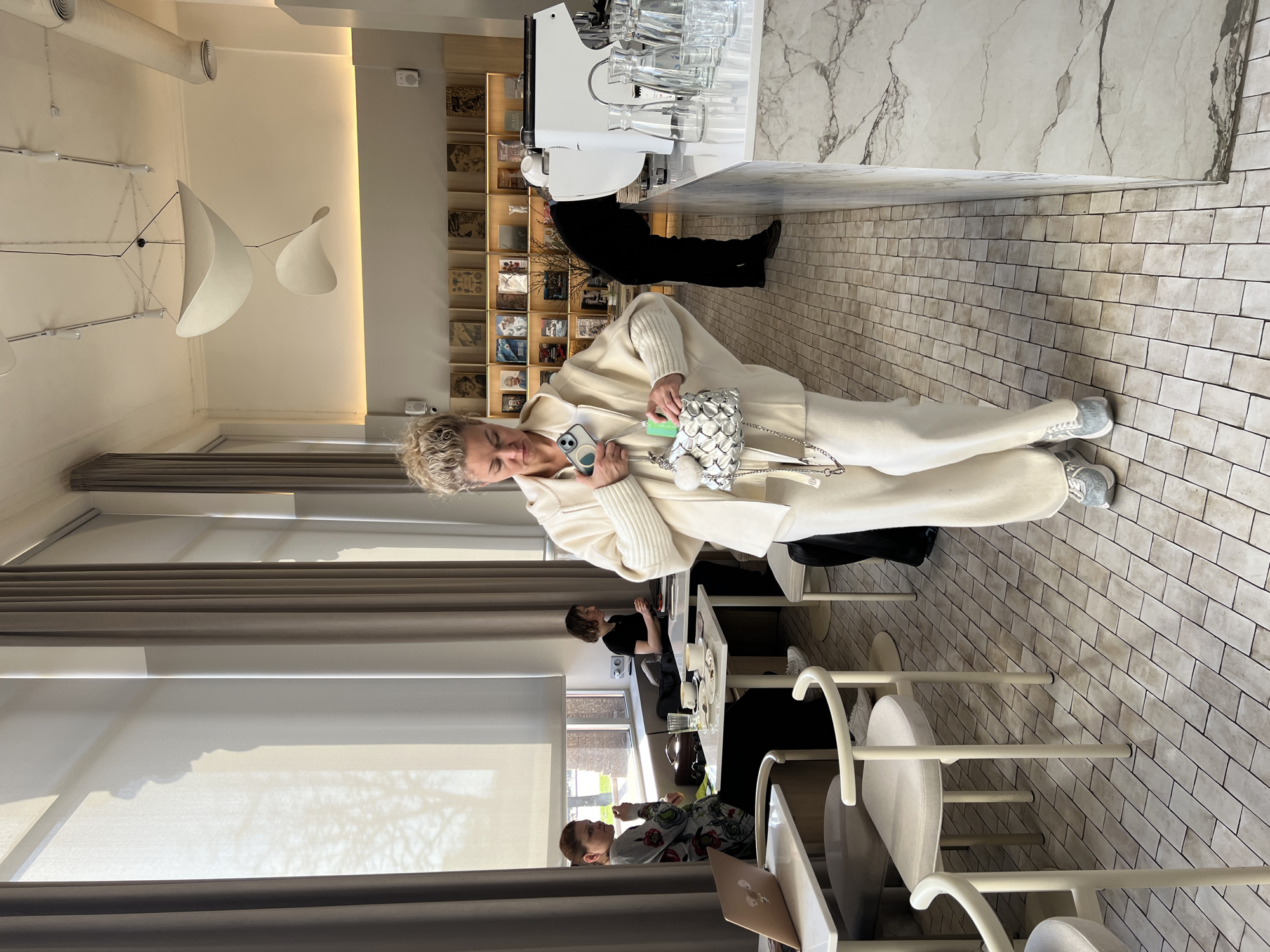 Woman enjoys coffee at Minsk café during spring afternoon