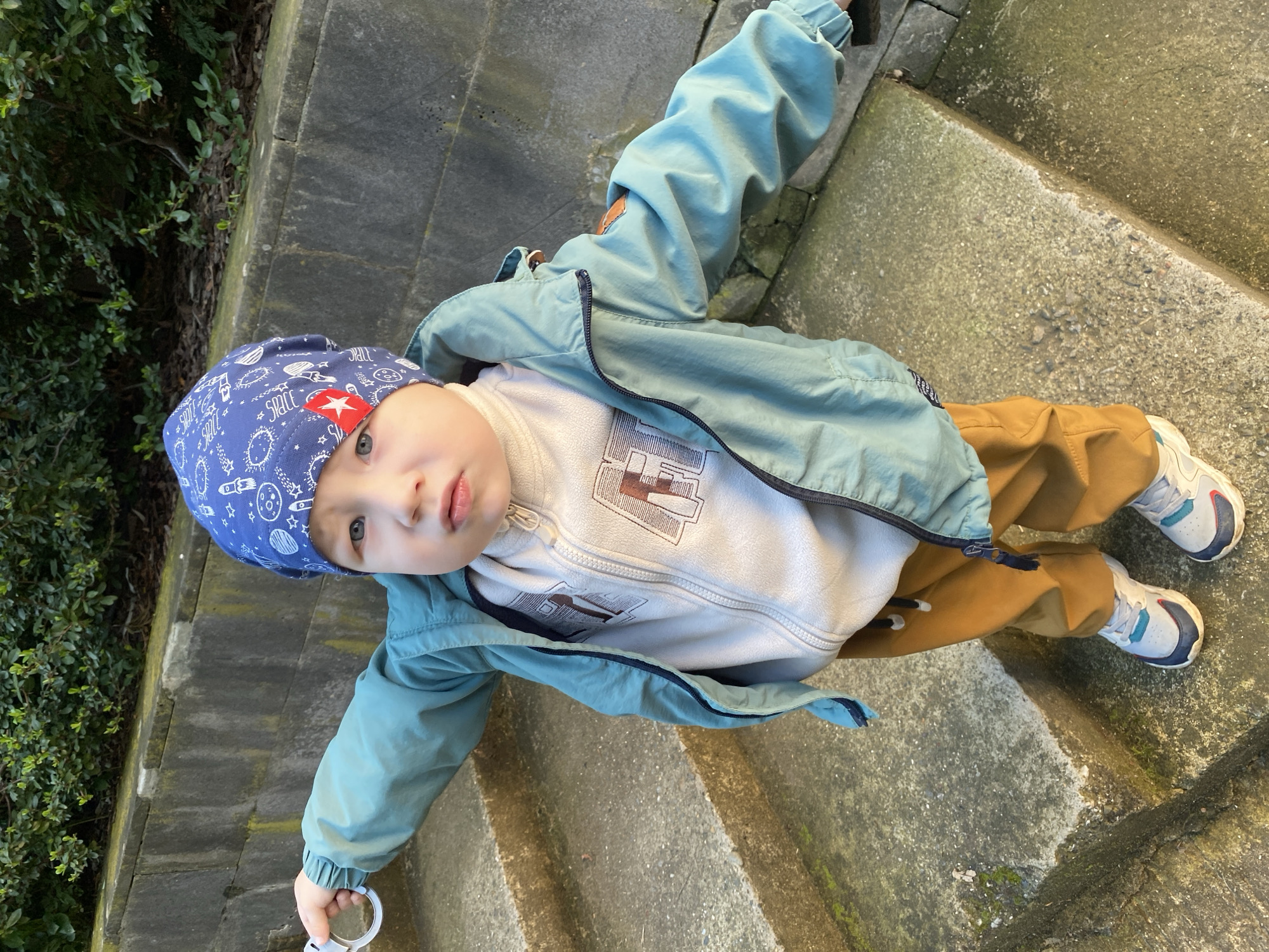 Child in space-themed outfit climbs stairs in Sochi