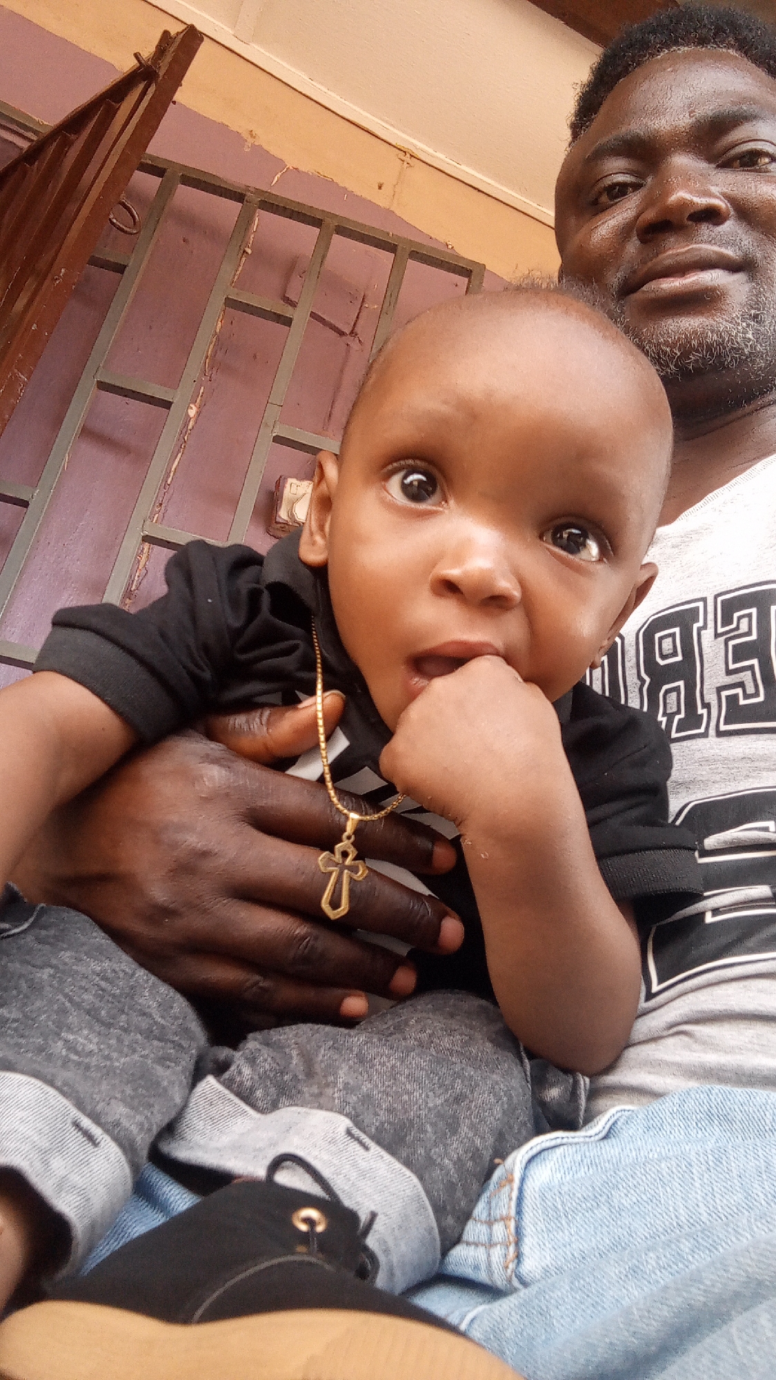 Man takes selfies with baby in Sabon Tasha, Nigeria