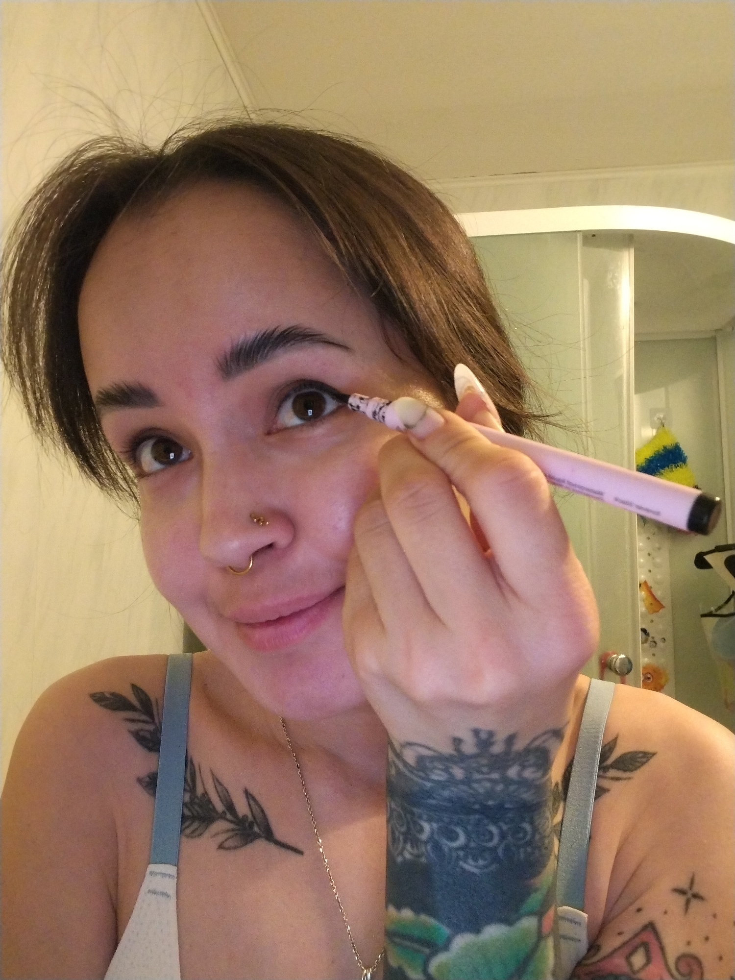 Woman applies makeup during early morning routine