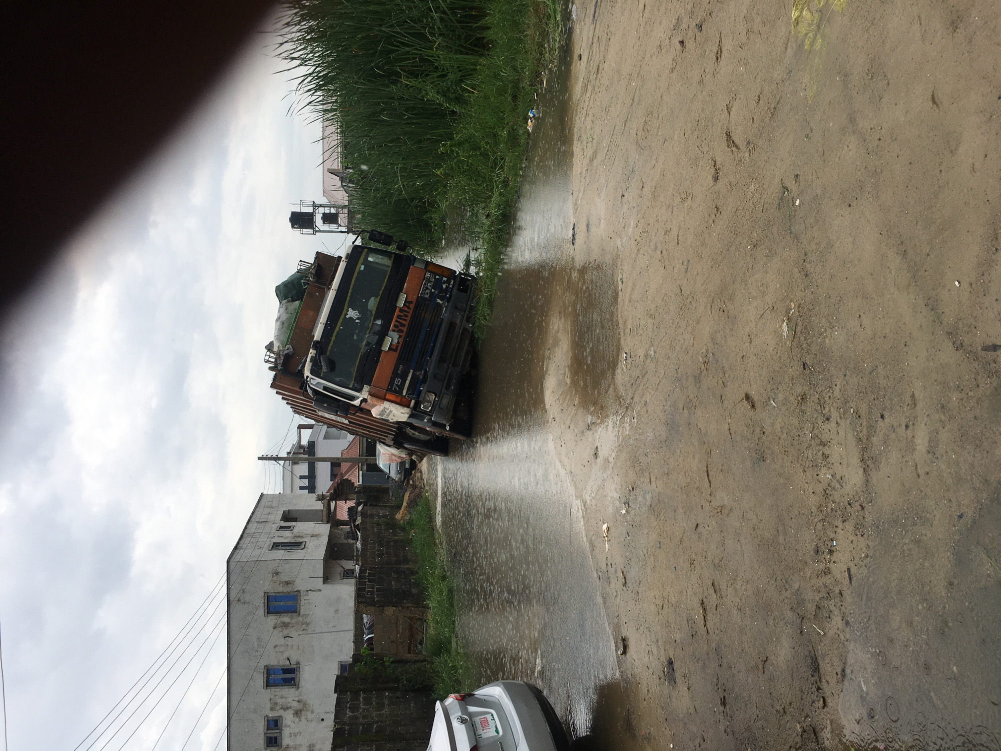 Utility truck tilts, submerges in Ado Nigeria floodwaters