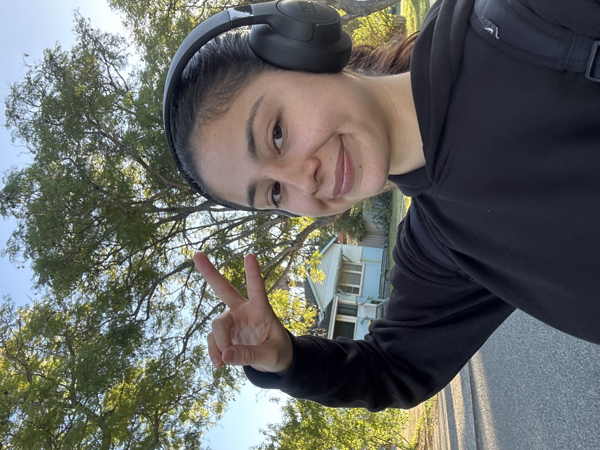 Person takes nighttime selfie with peace sign in Calista