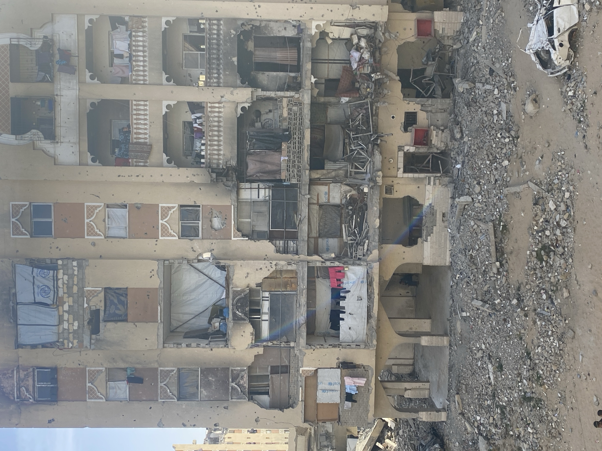 Damaged buildings and people documented in Khan Yunis