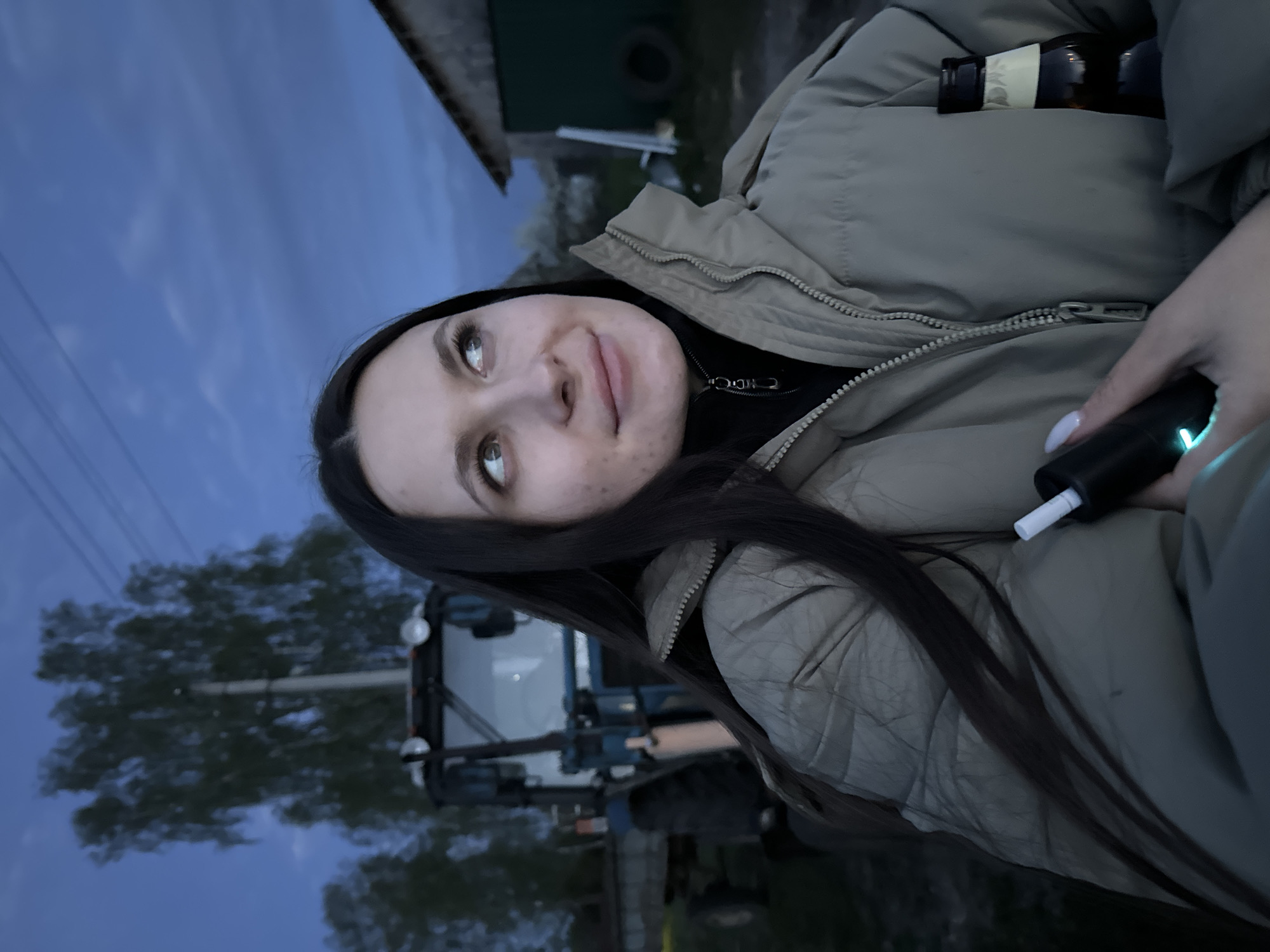 Family gathers around tractor at dusk in rural Russia