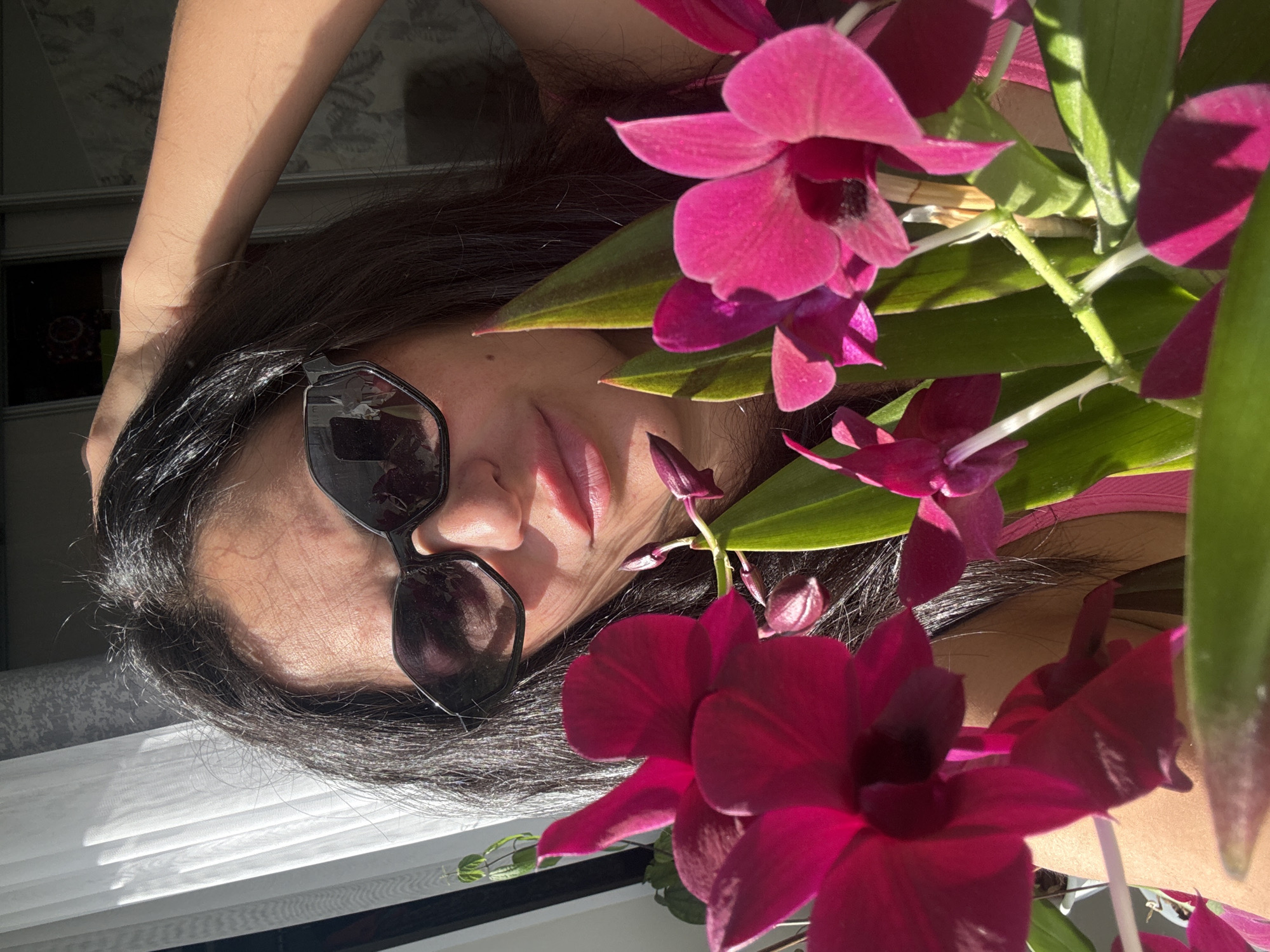 Woman photographed with orchids in Russian flower arrangement session