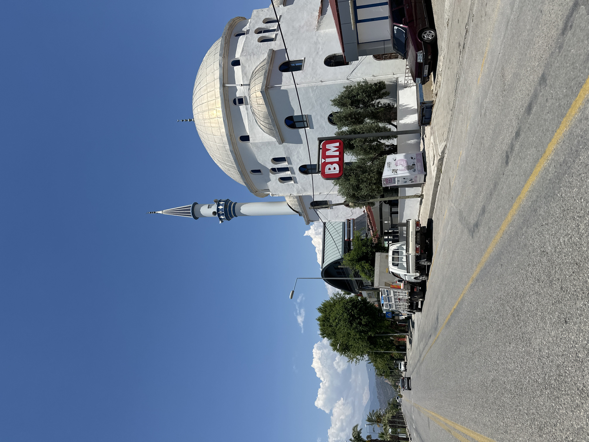 White mosque photographed on Fethiye street under clear skies