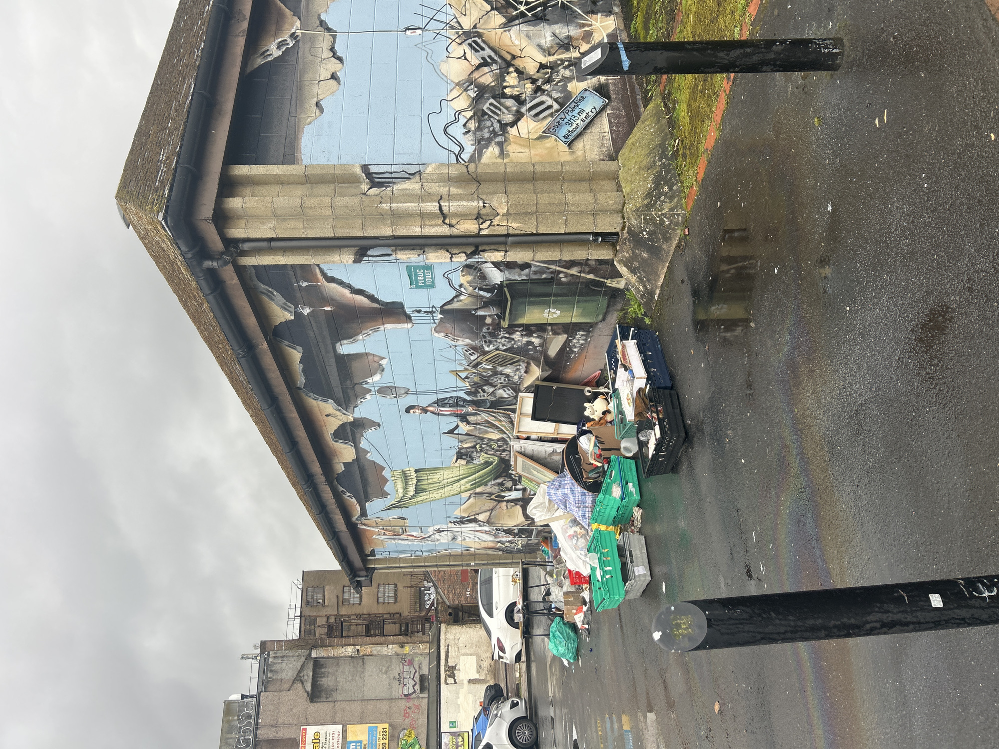 Street art documented in Glasgow including war mural, woman stencil
