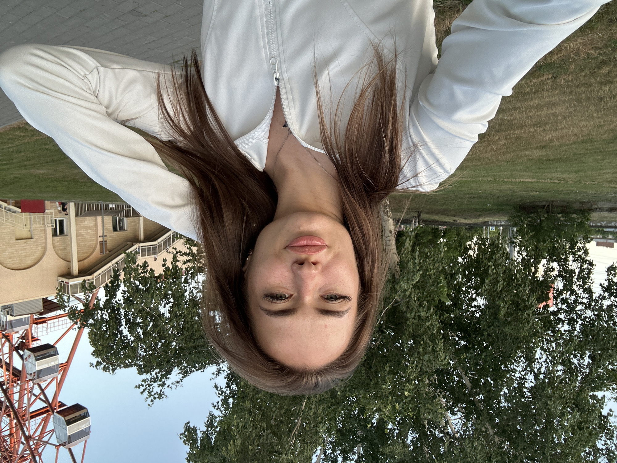 Selfies and scenic shots at a riverside park with Ferris wheel