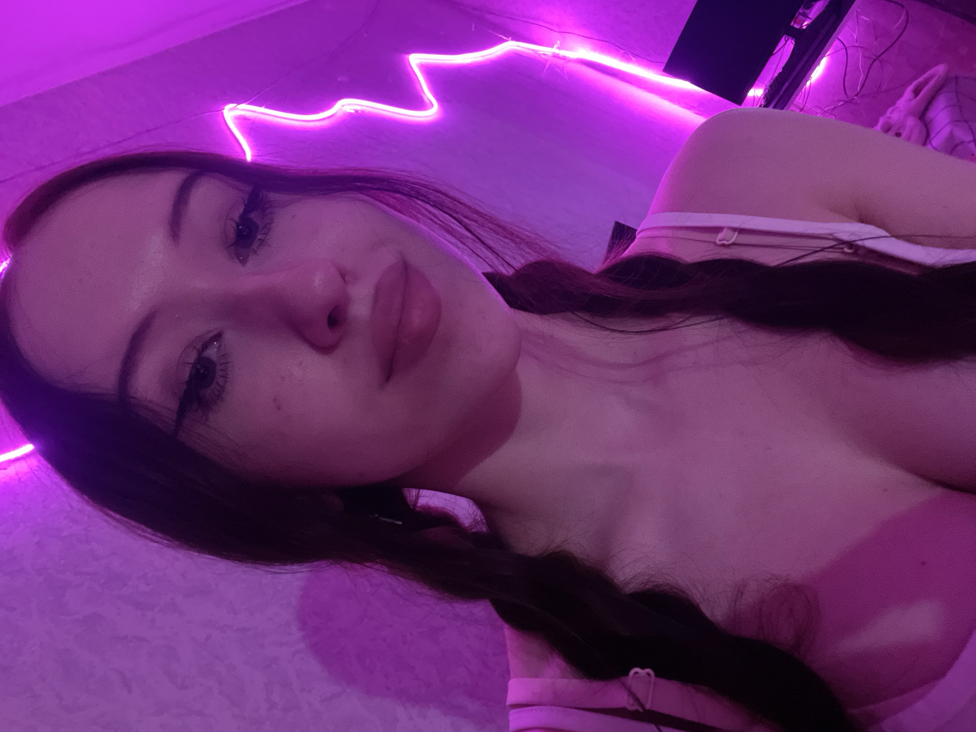 Woman takes selfies in purple-lit room in Votkinsk, Russia