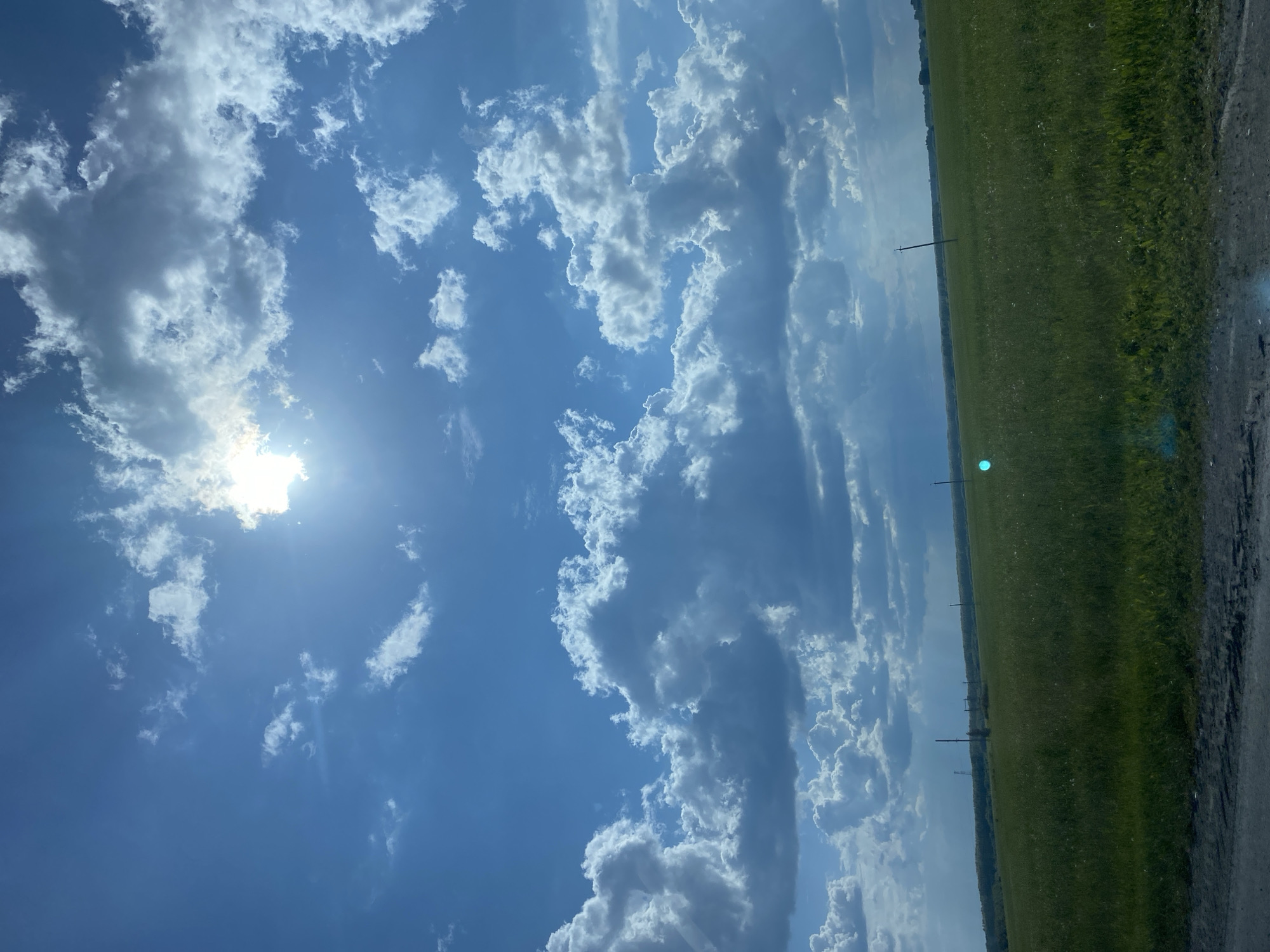 Dramatic skies over green field captured in Tyumen