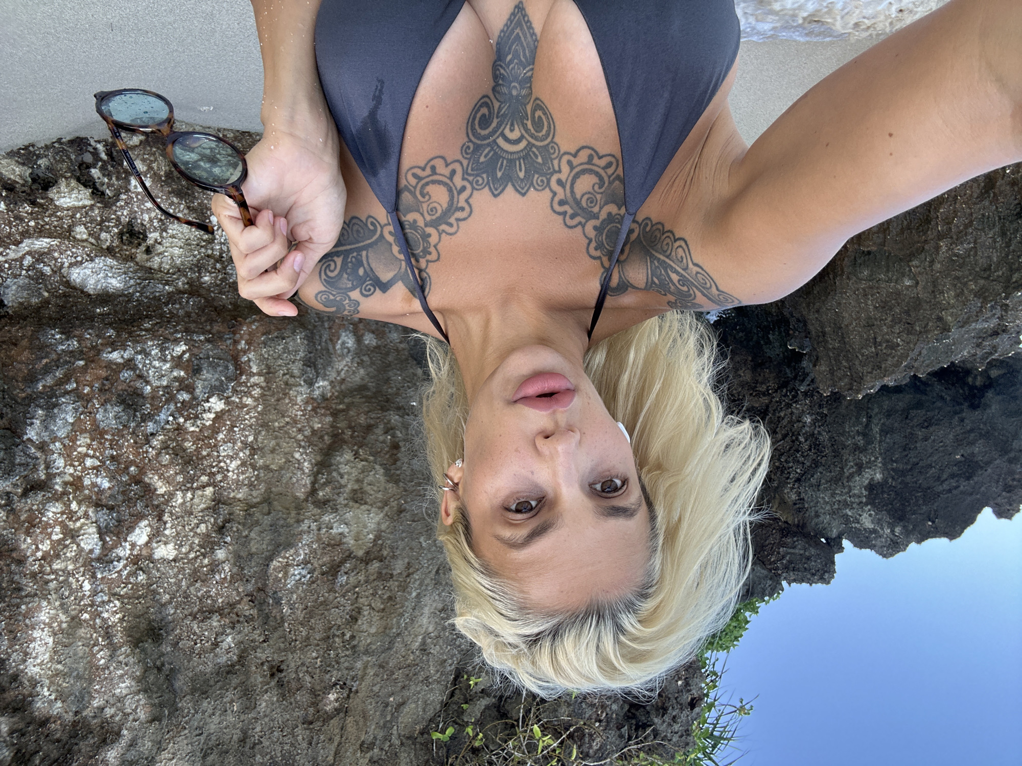 Beach selfie session near volcanic rocks, Kuta Selatan, Bali