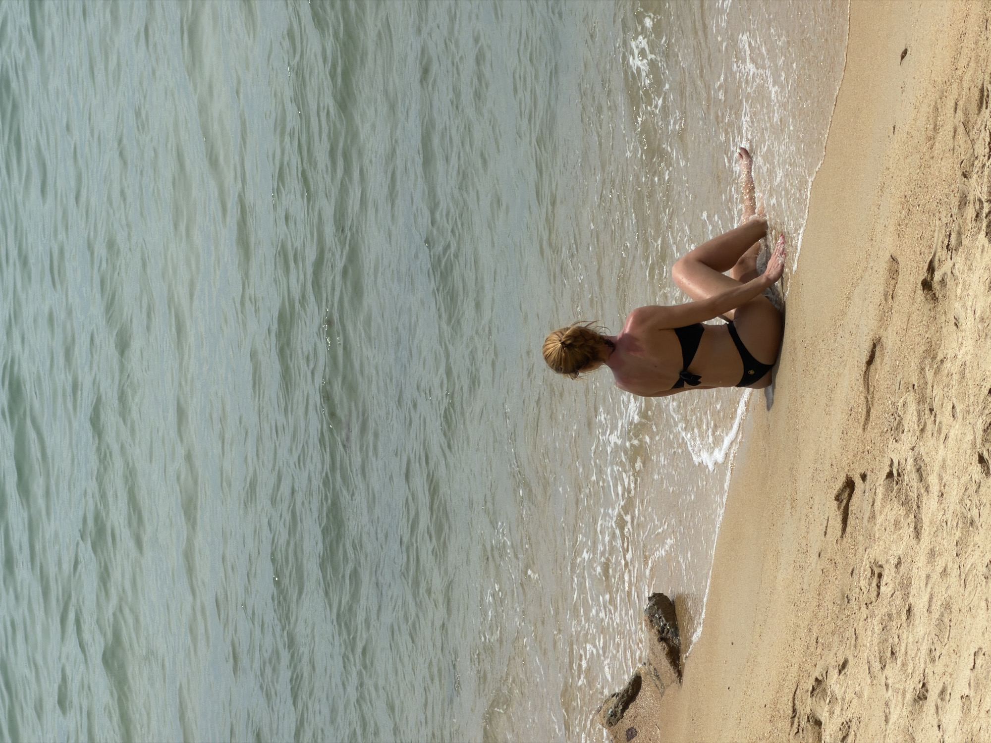 Busy morning on a Ko Samui beach — swimming, strolling, vendors