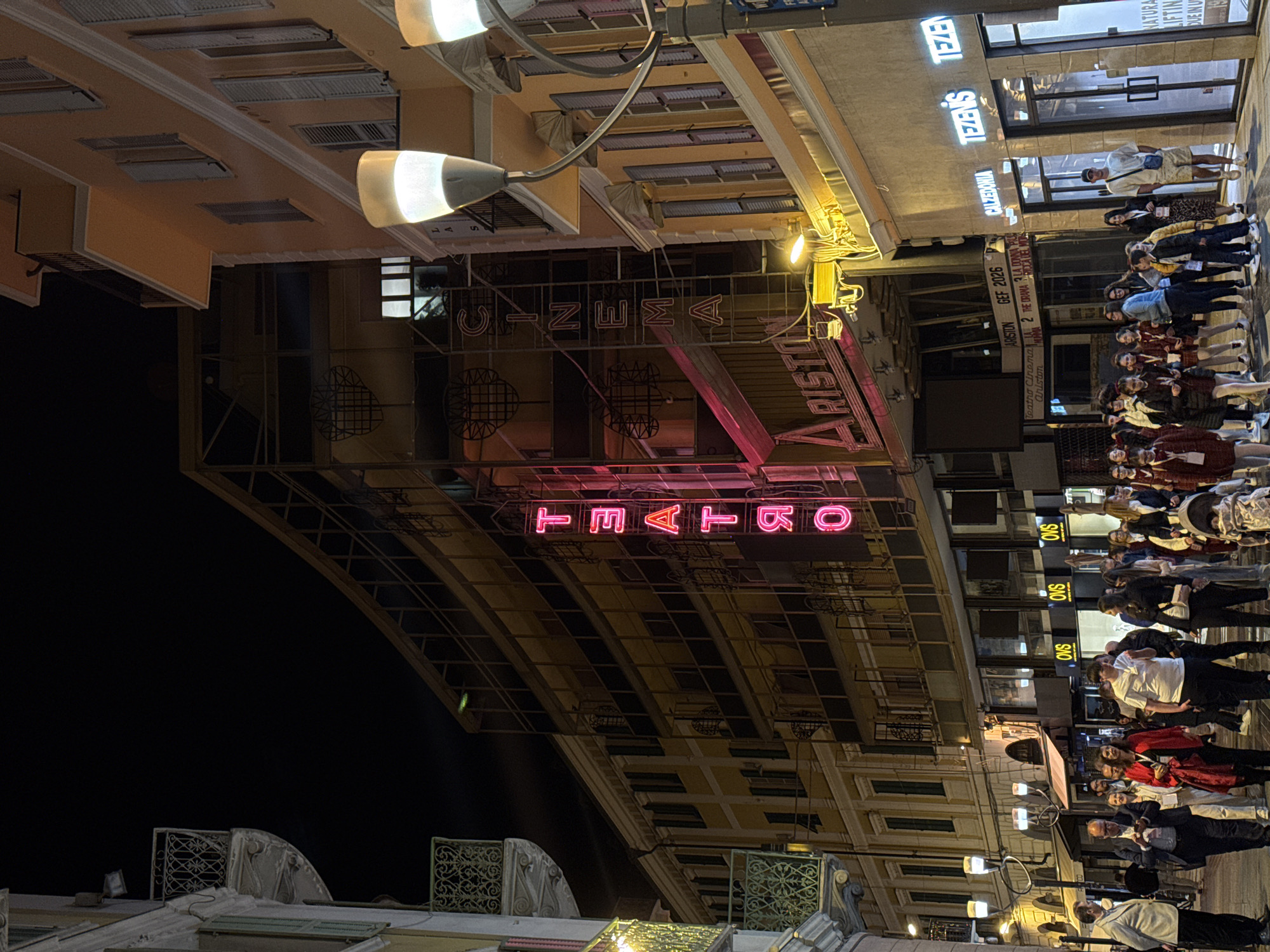 Crowd gathers near Cinema Ariston in Sanremo evening scene