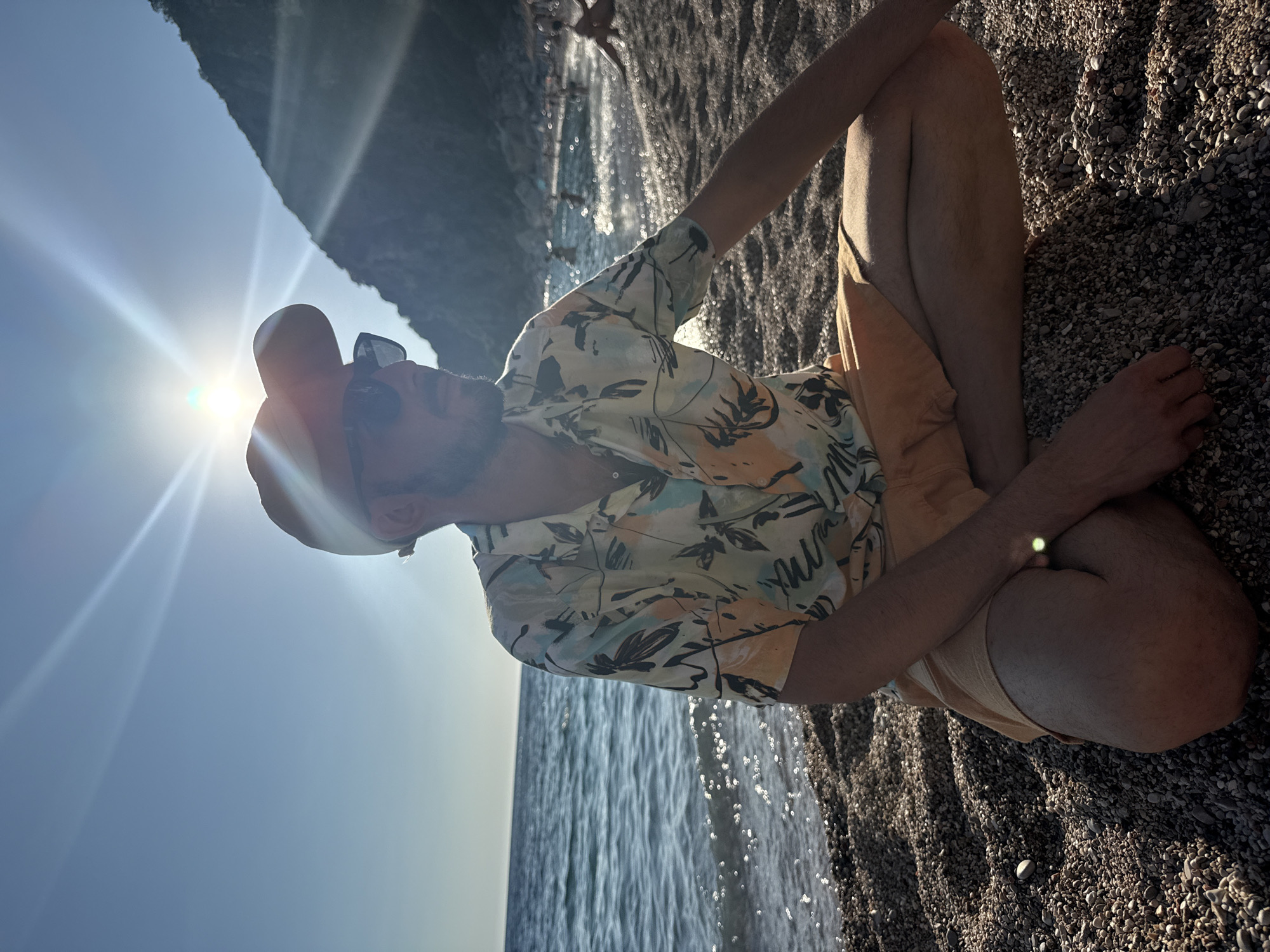 A relaxed afternoon on a pebble beach at sunset