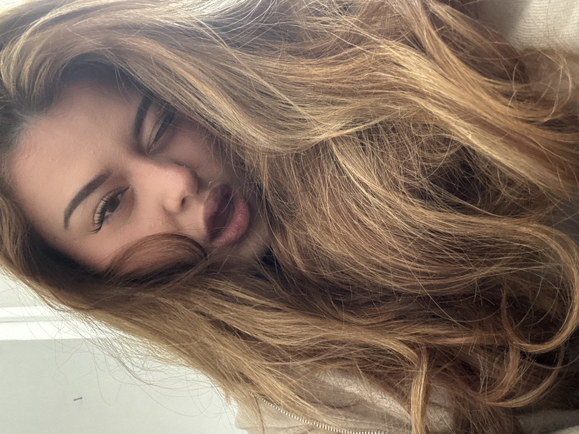 Woman takes playful selfies in Bulgarian office space