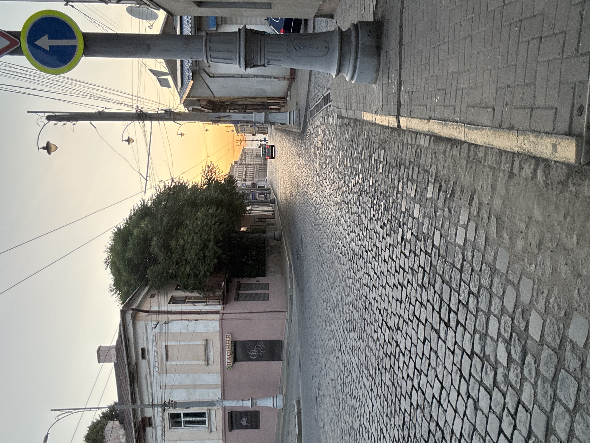 Chernivtsi cobblestone streets and rising moon at golden hour